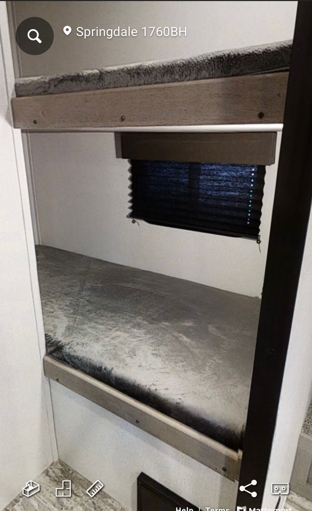 Inside an RV rental: two stacked bunk beds with mattresses and a dark window blind. Springdale 1760BH bunkhouse interior.. Keystone Springdale 2022