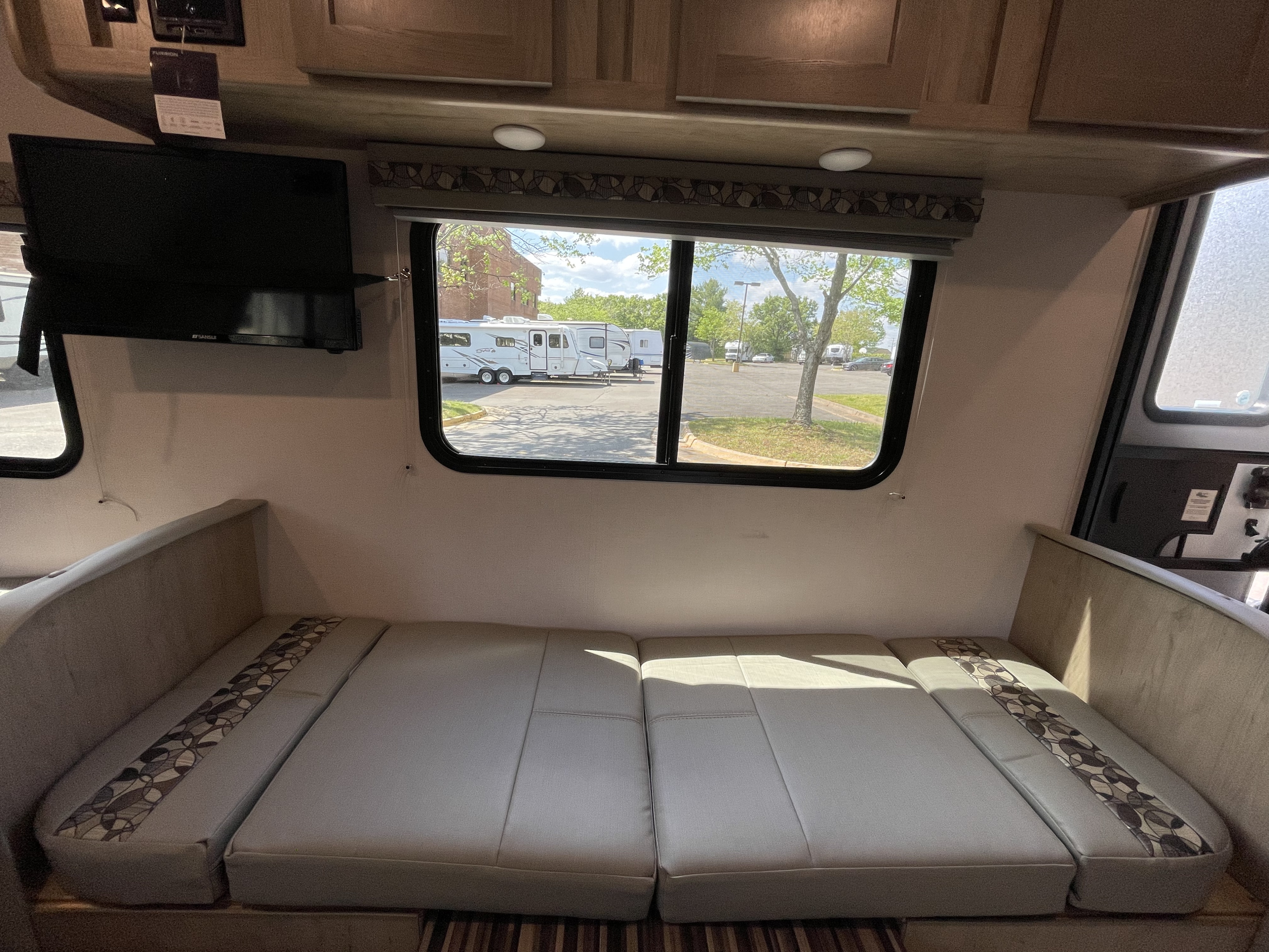 RV rental interior features comfortable bench seating, a TV, and a window with an outdoor view. Perfect for travel.. Forest River R-Pod 2021