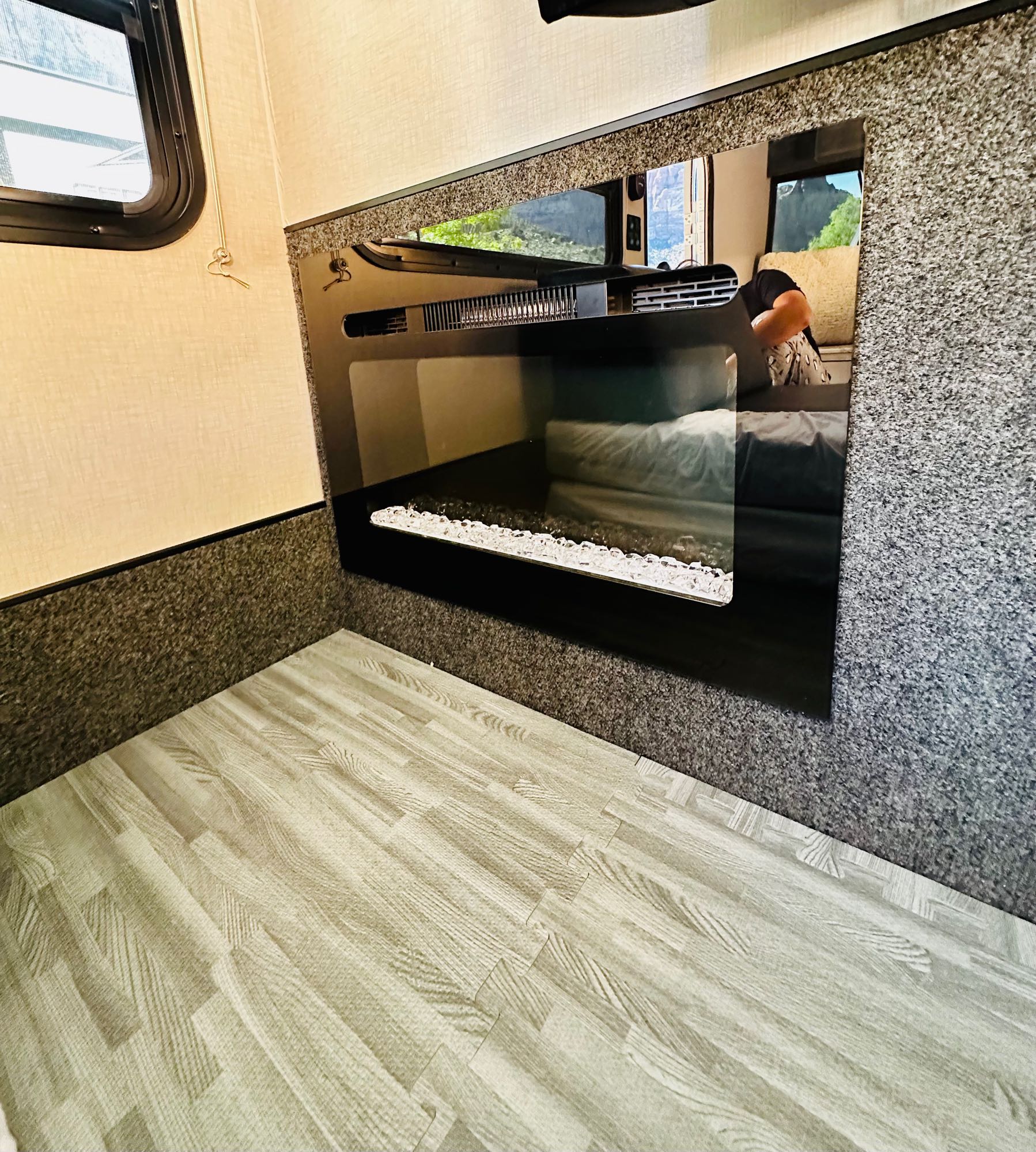This RV rental features a cozy electric fireplace, wood-look interlocking floor, and a large window.. InTech RV InTech RV Trailer 2021