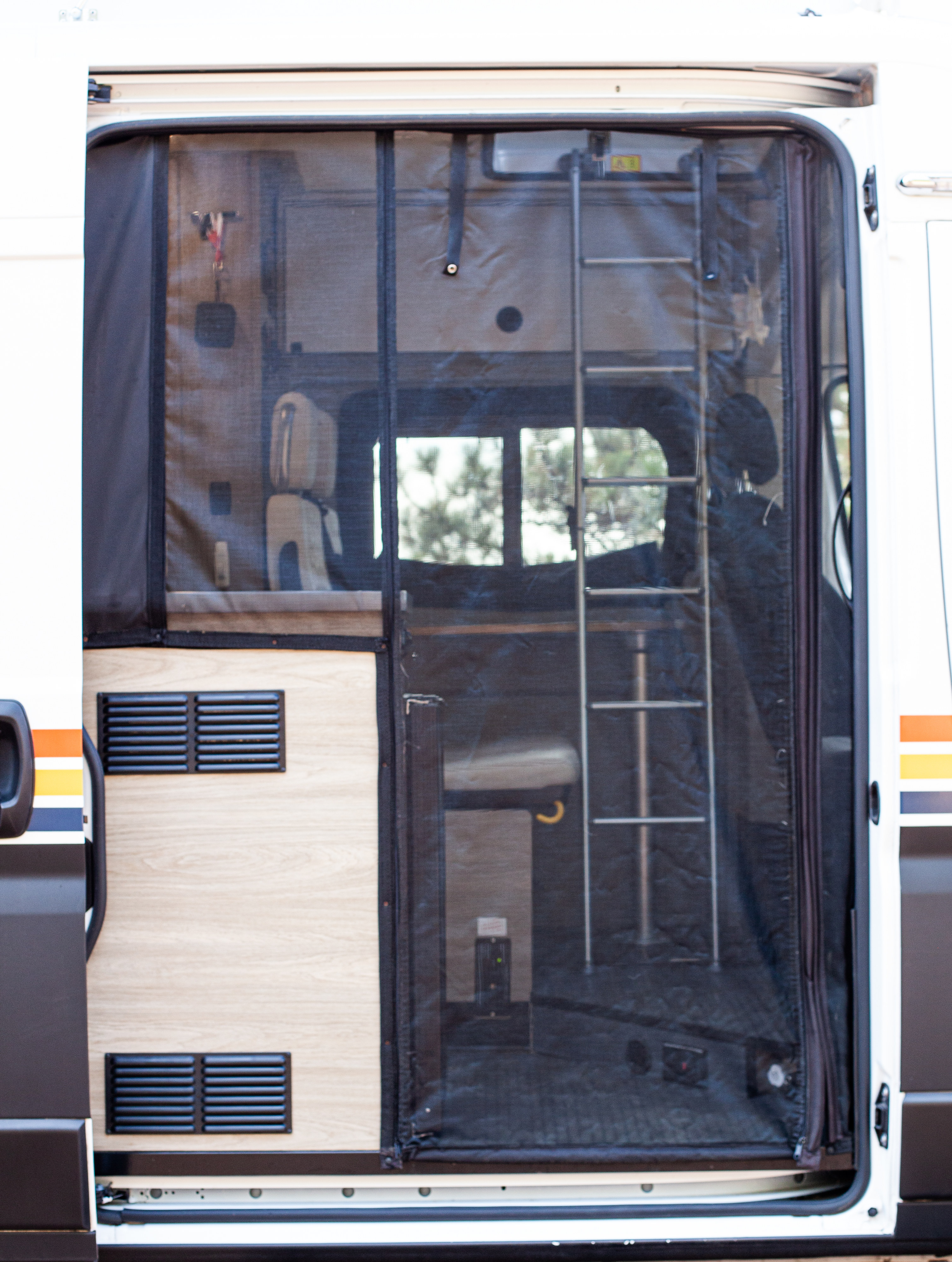 RV rental: Open side door and mesh screen offer a peek into the cozy van interior with a ladder and vents.. Winnebago Solis 2021