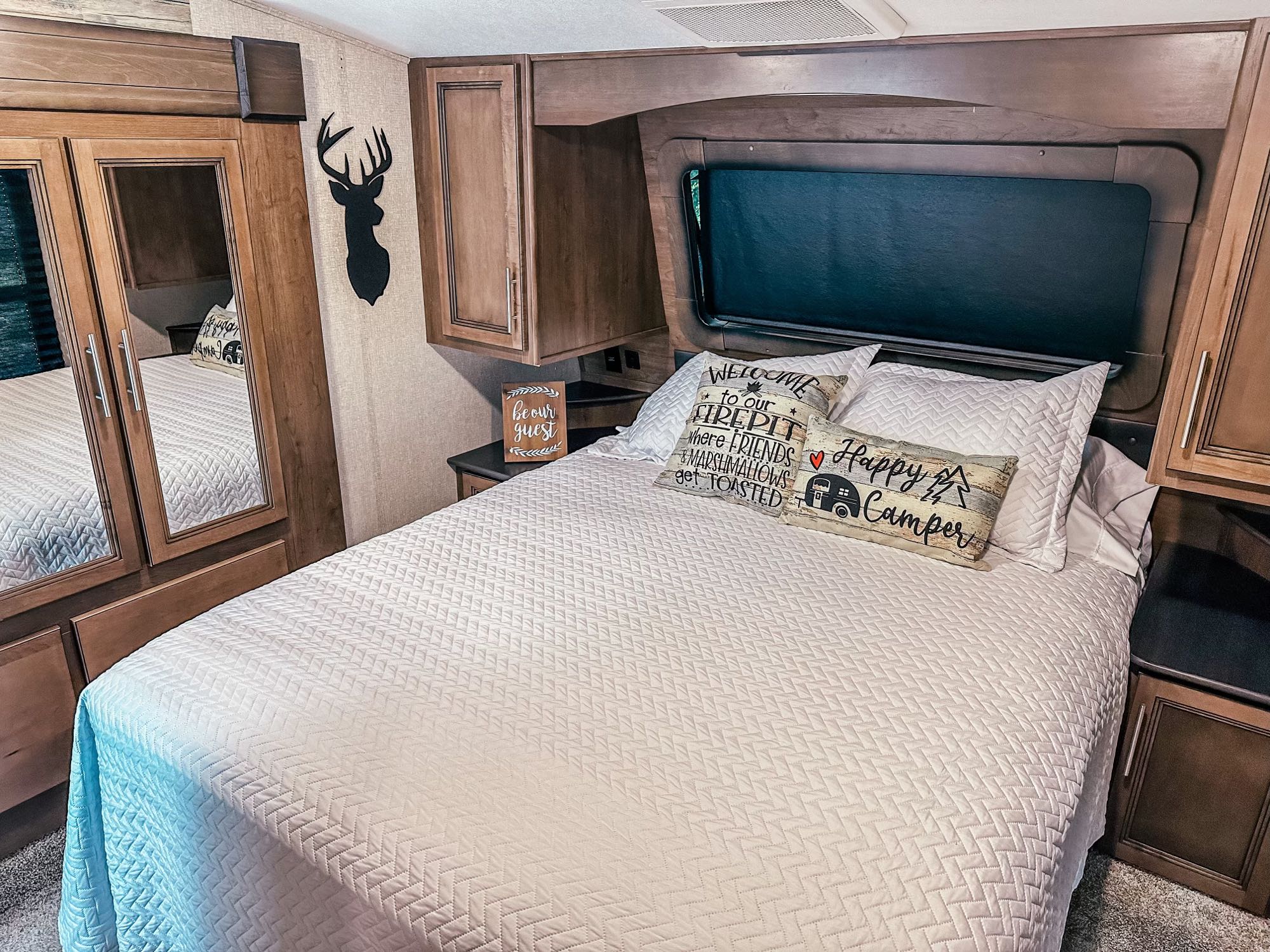 Main private bedroom w/ Queen bed with walk around access on both sides and USB charging stations at both nightstands. . Keystone RV Cougar 2021