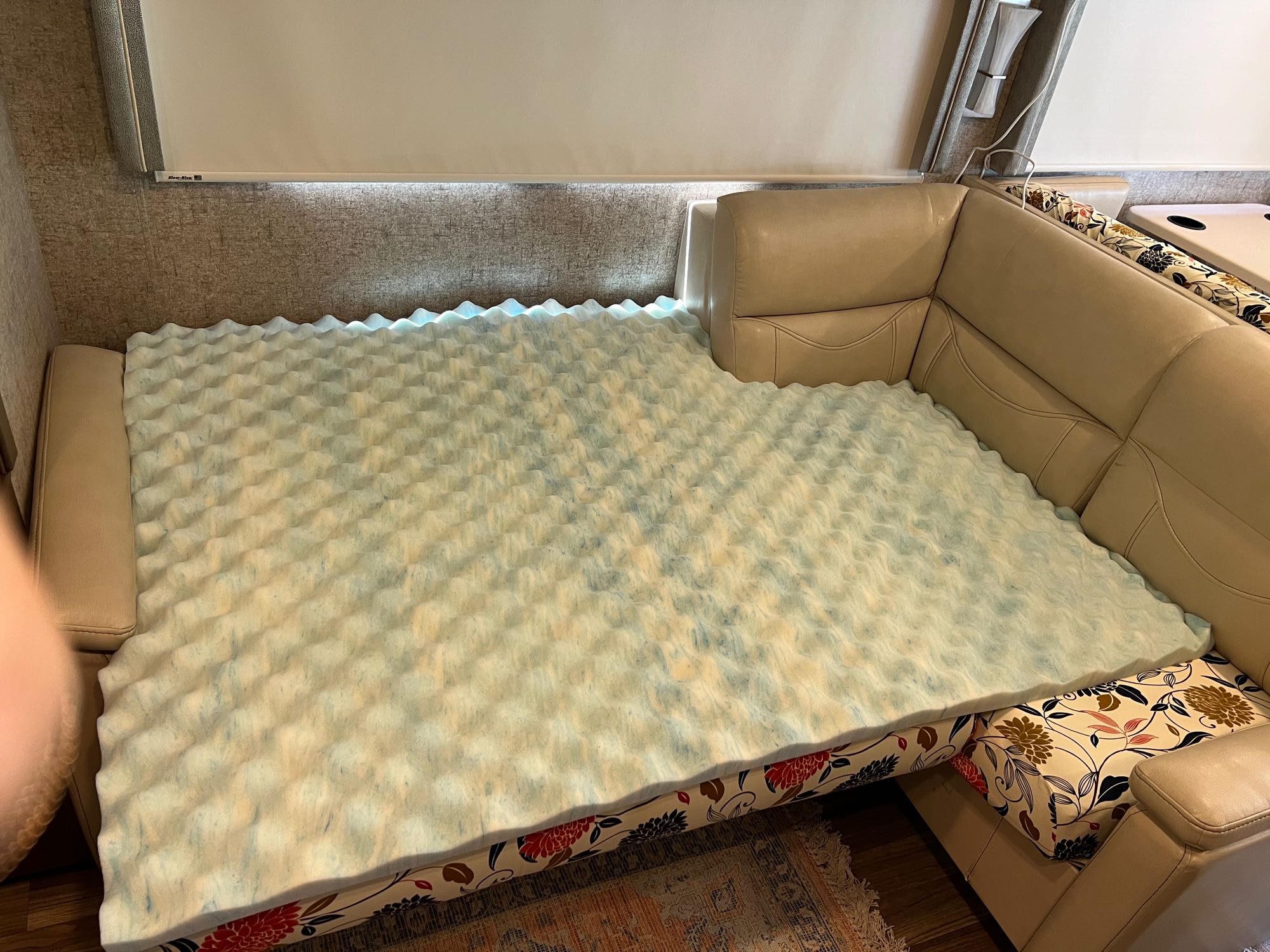 RV rental interior: A comfortable sofa bed featuring a wavy foam topper on a floral base, optimized for sleep.. Thor Miramar 2018