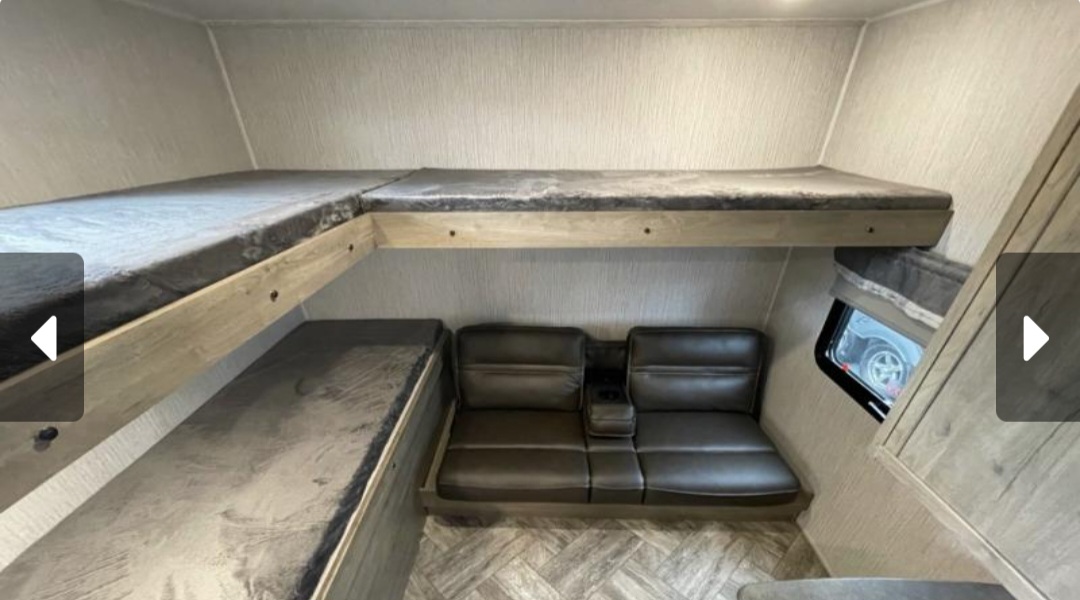 RV rental bunkhouse: L-shaped top bunk, lower bunk, and sofa with cup holders. Ready for family adventures!. Forest River Palomino Puma 2023