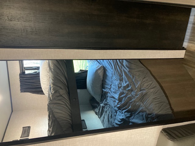 RV rental: Inside, two stacked bunk beds with bedding and a window provide cozy sleeping. Ideal interior for family adventures.. Starcraft Autumn Ridge 2023