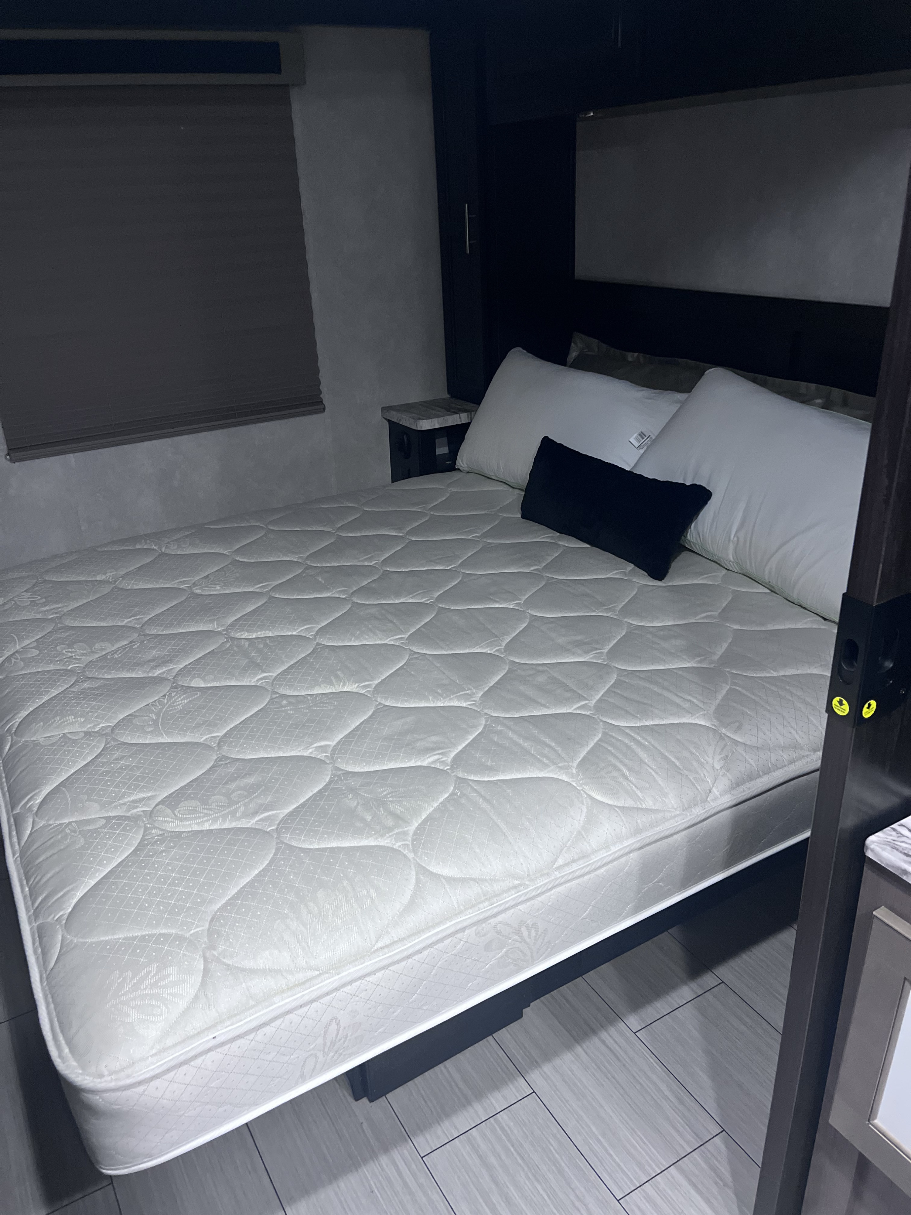 Comfortable RV rental bed featuring a clean quilted mattress, white pillows, and a compact bedroom design.. FR3 FR3 Motorhome 2019
