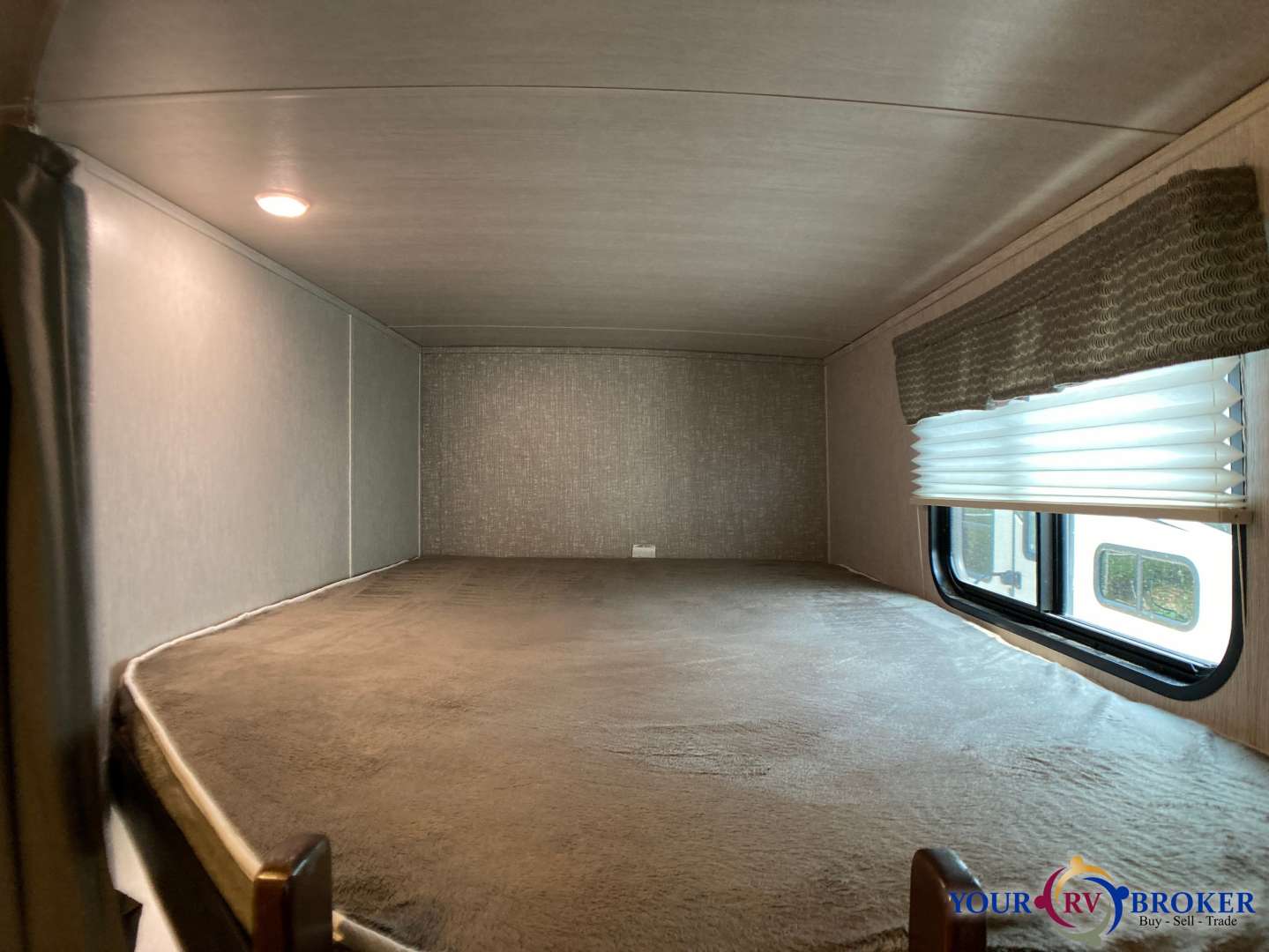 Comfortable RV rental bunk bed space with cozy mattress, window, blinds, and ceiling light. Perfect for travel.. Heartland RVs Mallard 2019