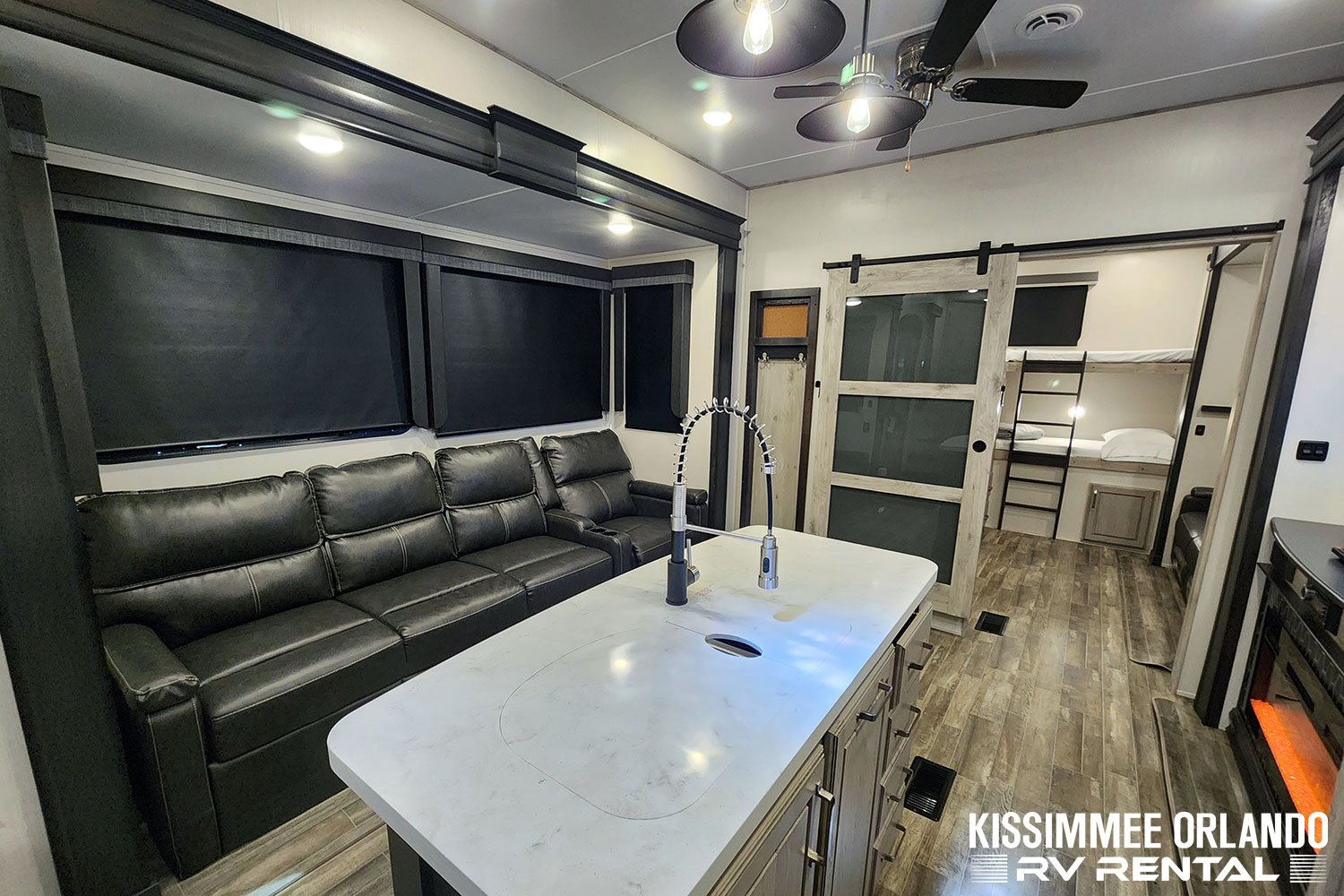 RV rental: Modern RV living area featuring a large leather sofa, island kitchen, and private bunkhouse.. Keystone Avalanche 2022