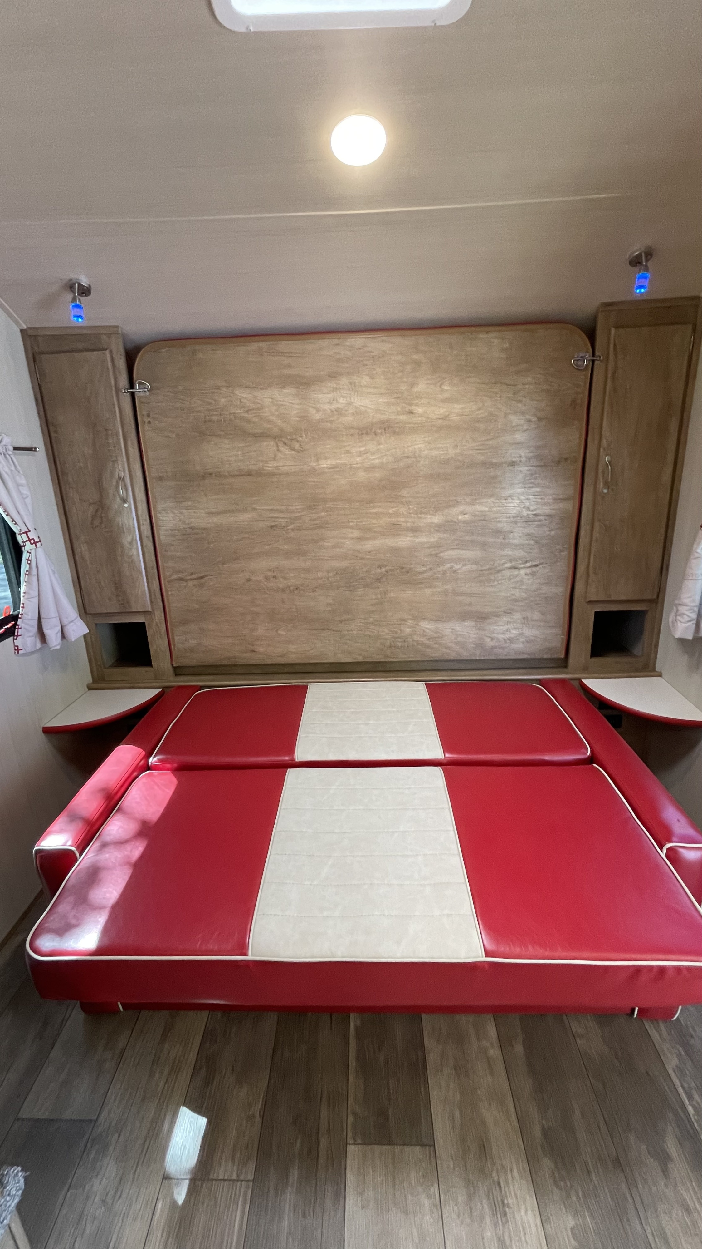 RV rental: Compact interior features a red/white convertible dinette/bed, wall-mounted murphy bed, and storage cabinets.. Gulf Stream Vintage Cruiser 2021