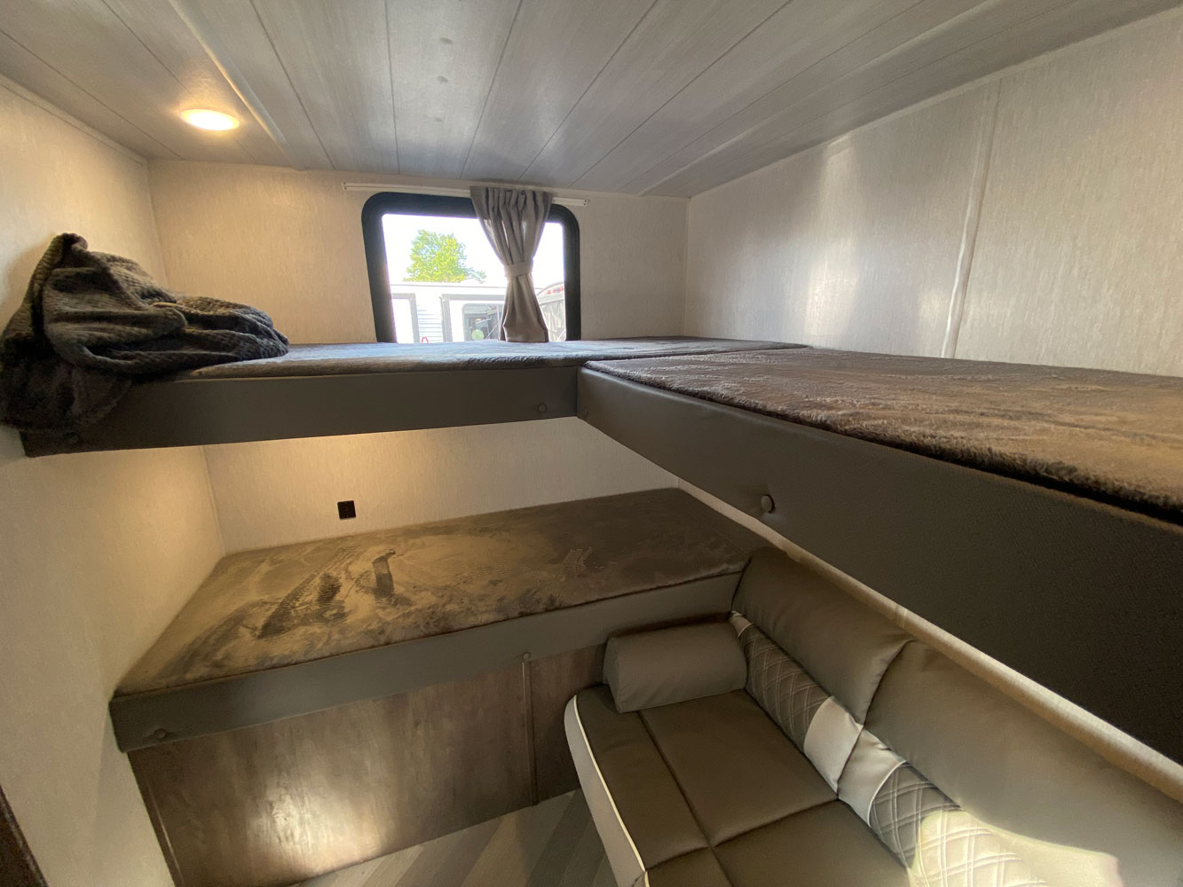 RV rental interior: two upper bunks, one lower bunk, and a comfy couch. Perfect for your next adventure.. Forest River Salem Cruise Lite 2021