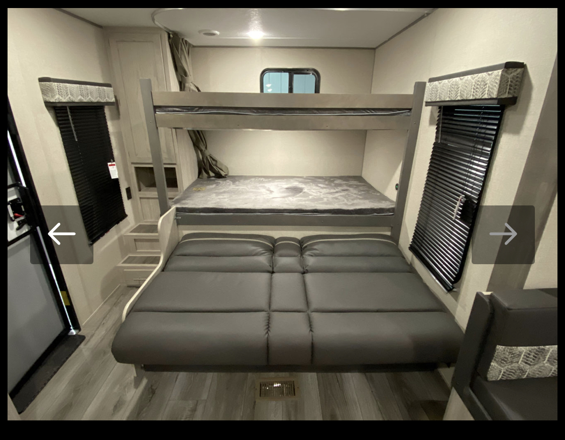 Spacious RV rental interior featuring comfortable bunk beds and convertible seating. Perfect for families on the go.. Coachmen Summit series 2023