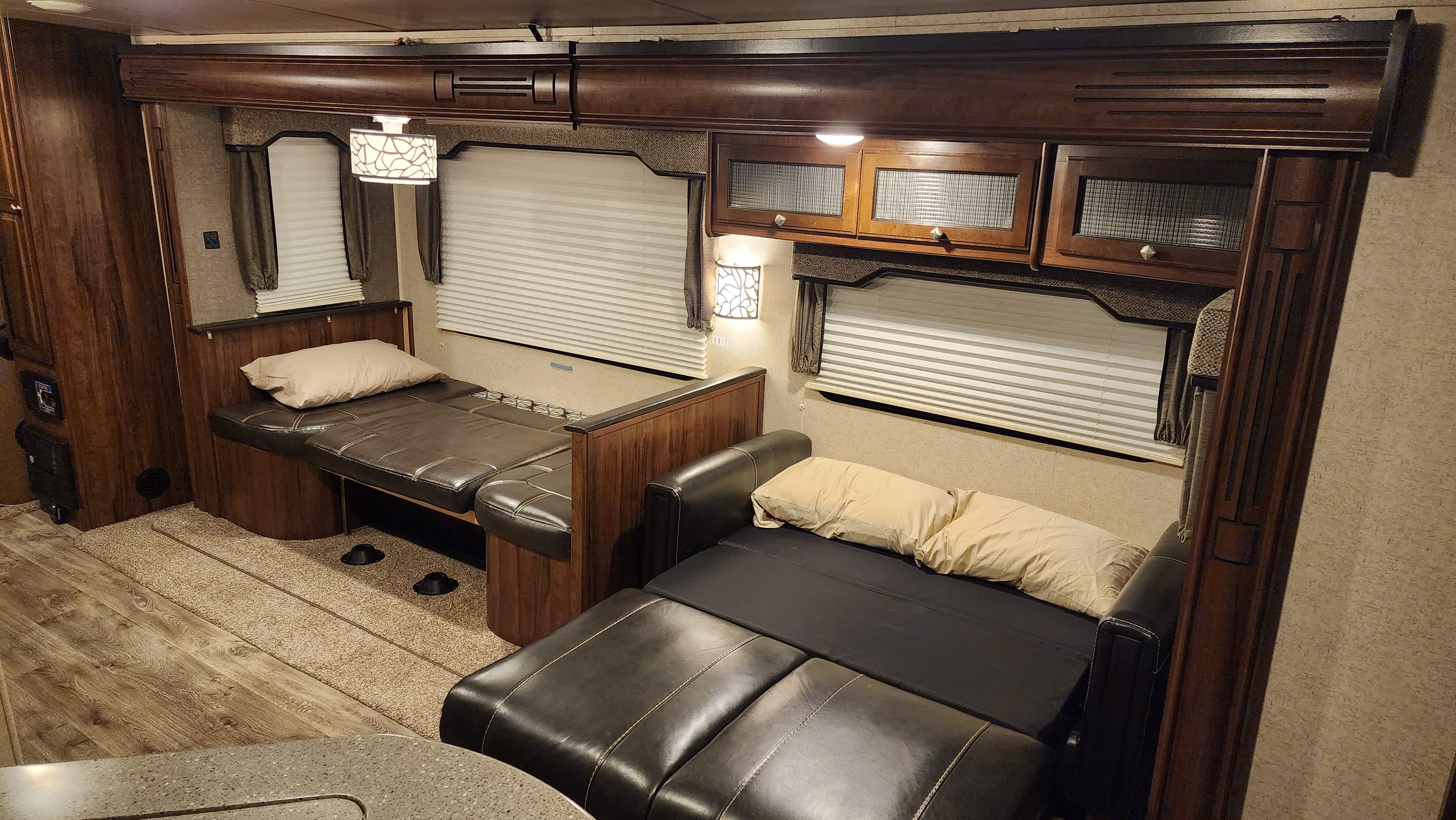 The dinette coverts into a single bed. The couch converts into a double bed. Memory foam toppers are included for added comfort.. Heartland RVs North Trail 2018