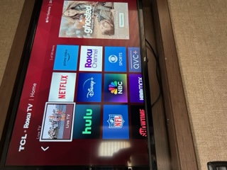 RV rental entertainment: A TCL Roku TV displaying streaming apps like Netflix & Hulu, perfect for winding down.. Thor Four Winds 2020