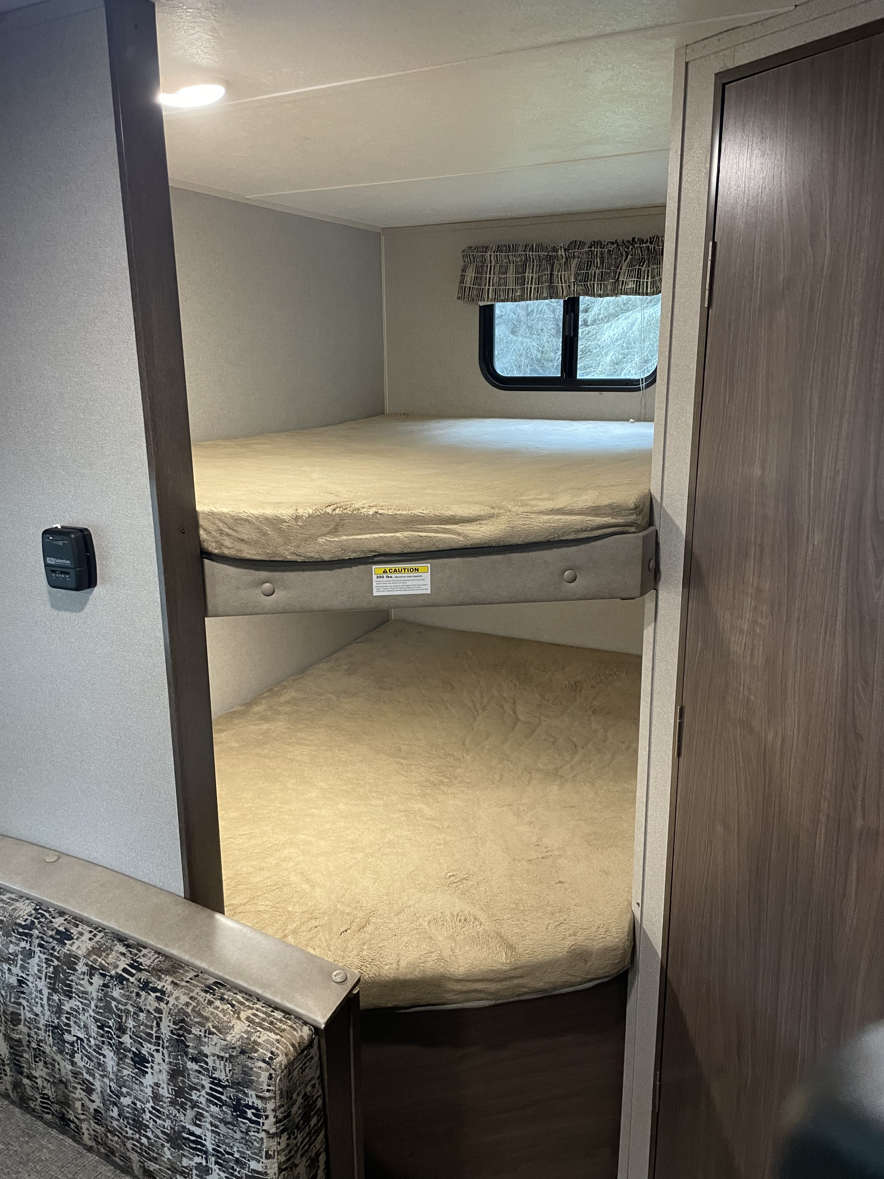 RV rental bunk beds (300 lbs capacity) with plush bedding, a window, and a thermostat. Perfect for family adventures.. Keystone Hideout 2018