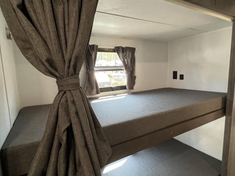 RV rental sleeping area with comfy bunk beds and privacy curtains, perfect for family travel.. Forest River Georgetown GT5 2023
