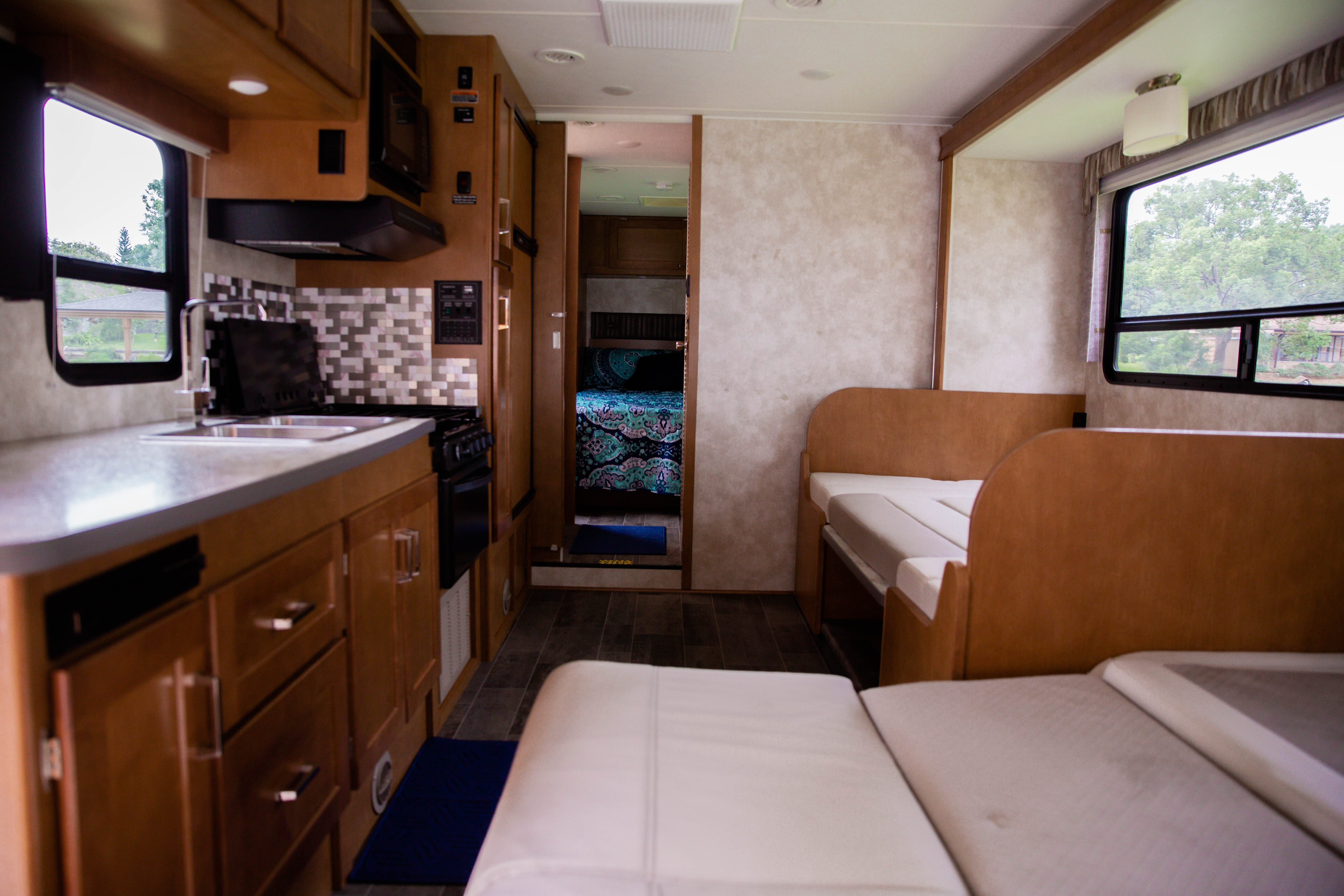 Spacious RV rental interior with full kitchen, dinette, and cozy rear bedroom. Ready for comfortable travel adventures.. Winnebago Spirit 2019