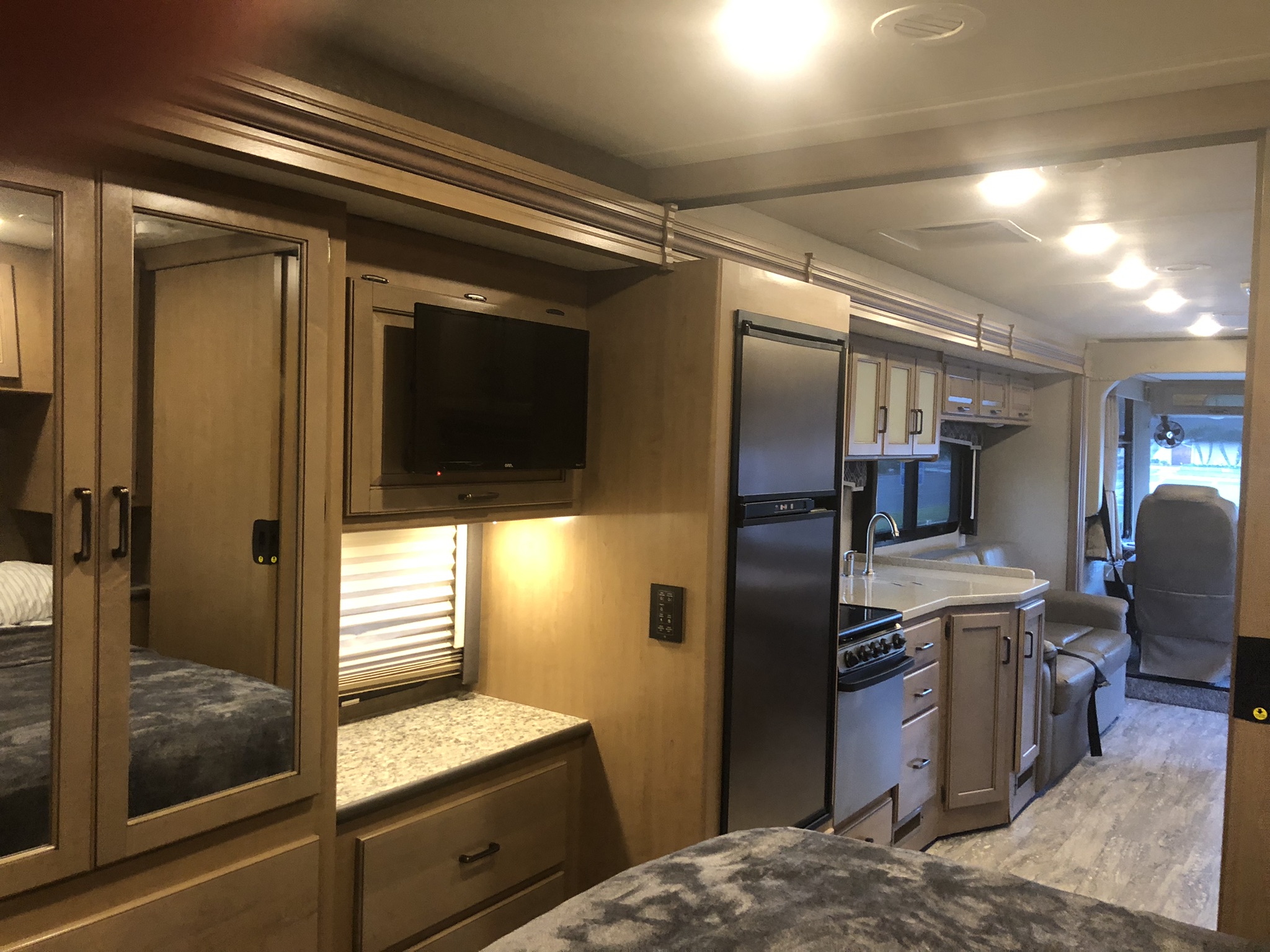 Well-designed RV rental interior showing a full kitchen, bedroom area, and forward living space with ample storage.. Thor Hurricane 2020