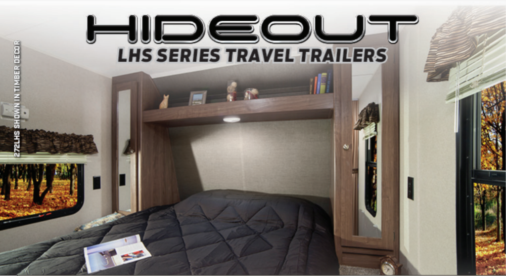 Inside a Hideout LHS Series travel trailer, this cozy RV rental bedroom offers comfort and scenic views.. Keystone RV Hideout LHS 2019