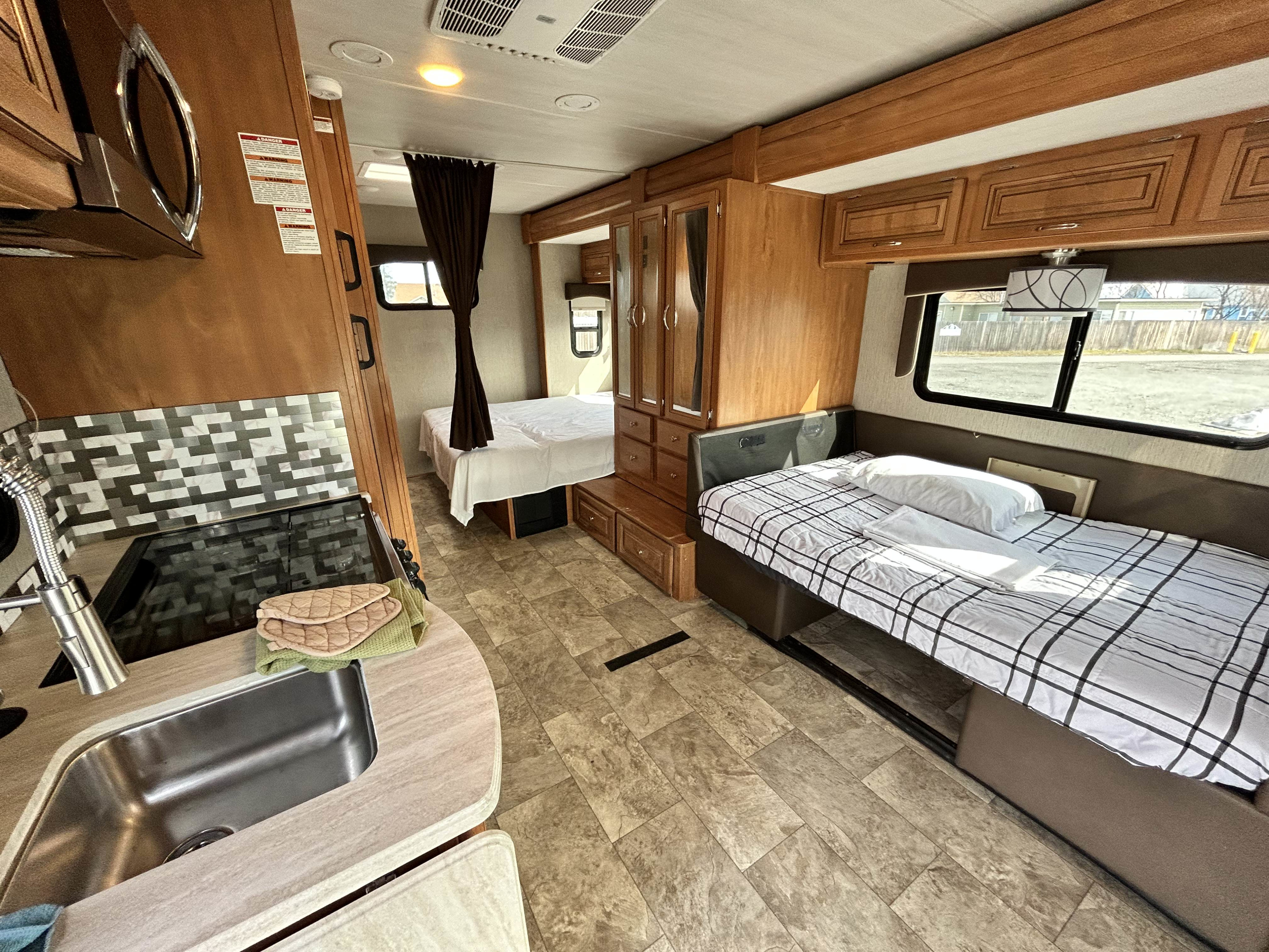 Explore this RV rental's spacious interior: full kitchen, main bedroom, and versatile lounge bed. Your adventure starts here!. Nexus Phantom 2019