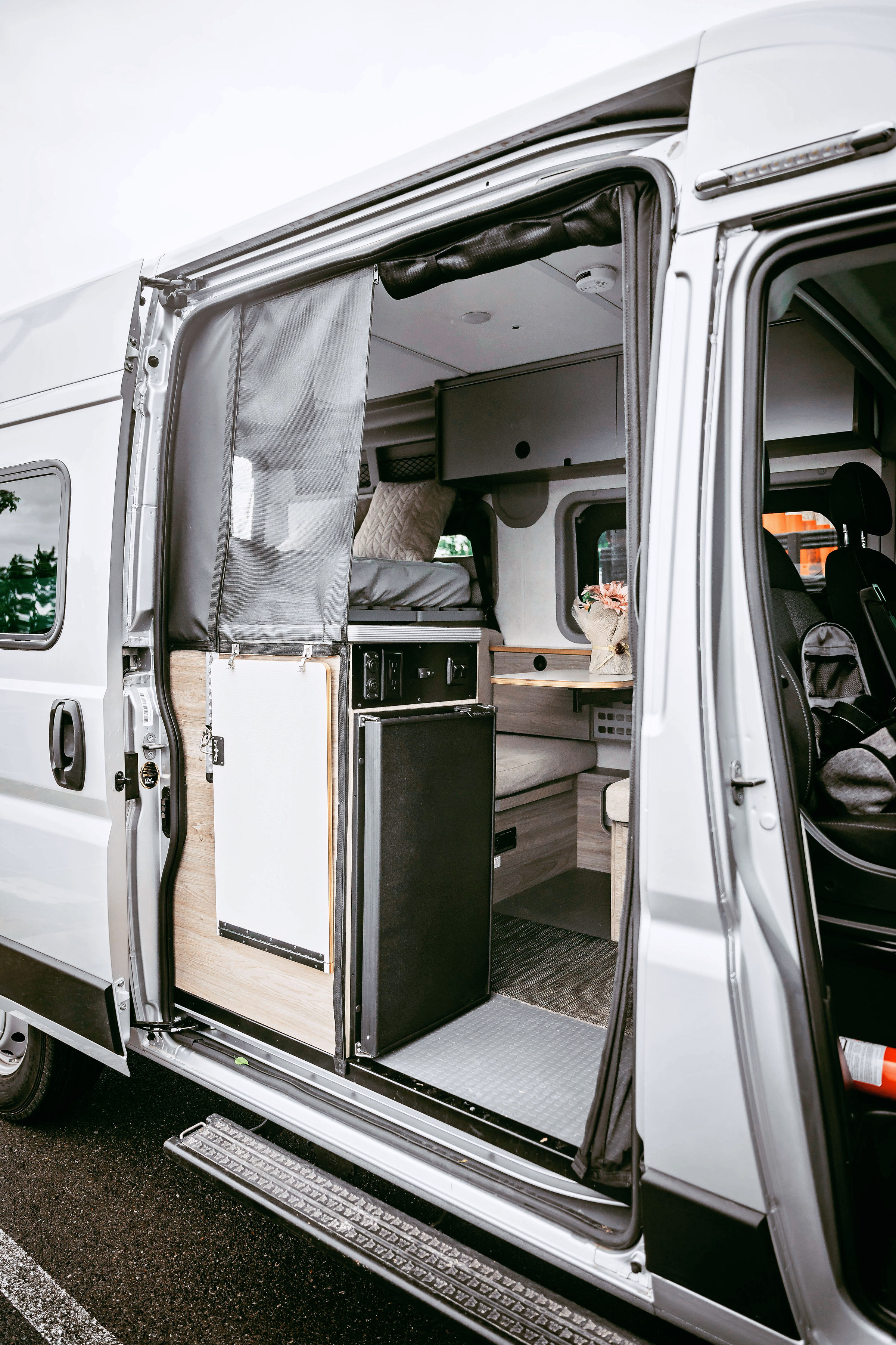 Step inside this RV rental! A well-designed camper van interior reveals a bed, living space, and amenities for your road trip.. Winnebago Solis Pocket 2022