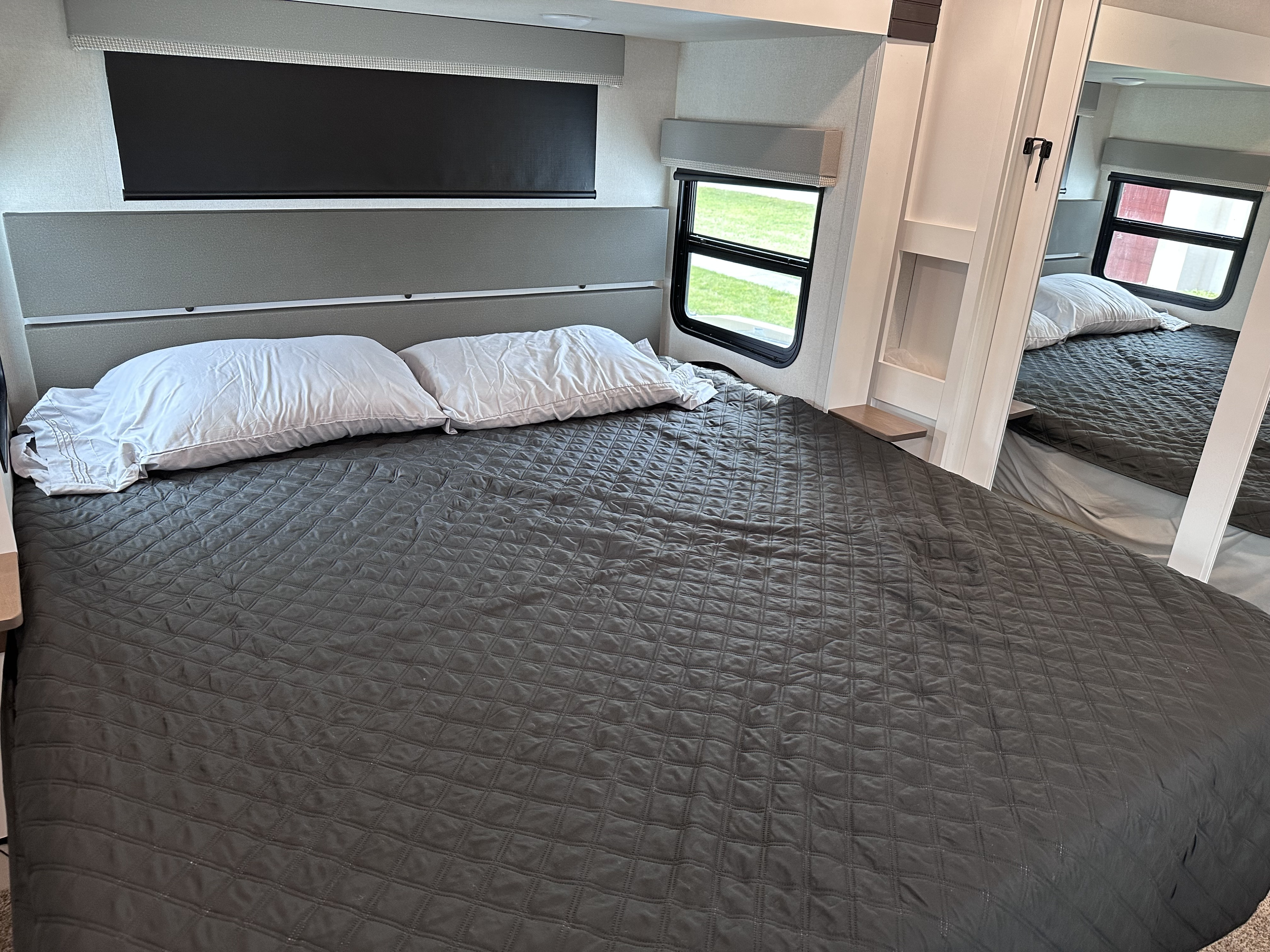 Cozy RV rental bedroom with a neatly made bed, white pillows, and quilted comforter, ready for your next adventure.. Crusader Crusader Fifth Wheel 2022