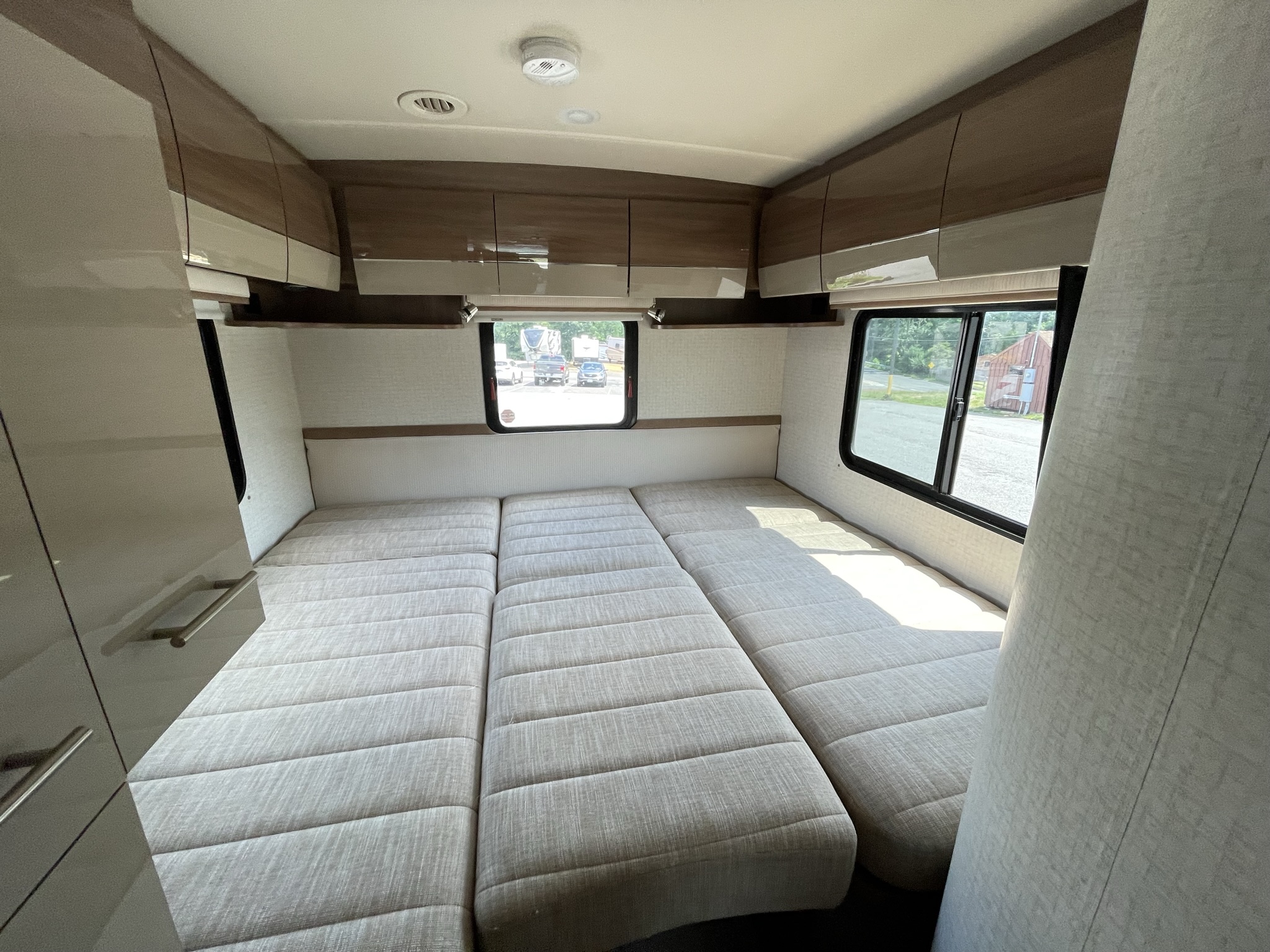 Spacious RV interior with modular bed/seating, modern cabinets, and large windows. Perfect for your next rv rental.. Itasca Navion 2015