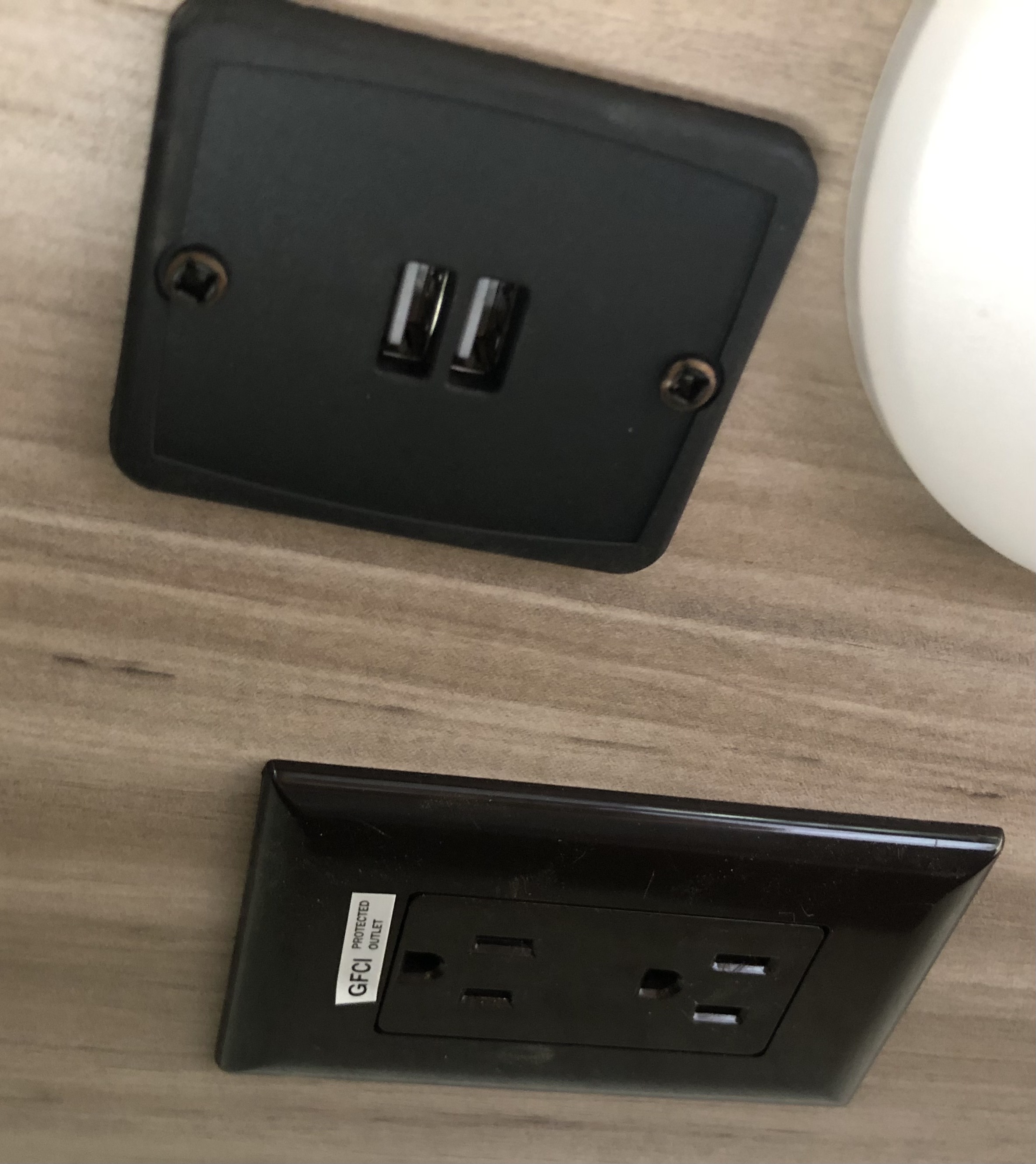 RV rental: USB and GFCI power outlets on a wood-grain panel, offering charging and protected power for travelers.. Winnebago Micro Minnie Delivery Only 2022