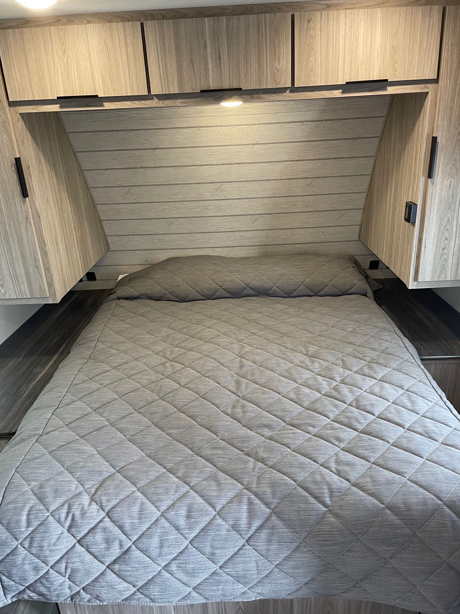 Comfy queen residential size bed (not a short RV queen). Keystone RV Passport SL 2021