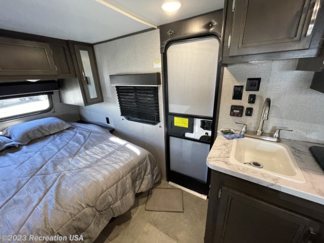 Inside this cozy RV rental: bed, kitchen sink, and entrance door. Perfect for your next adventure.. Jayco Jay Flight 2020