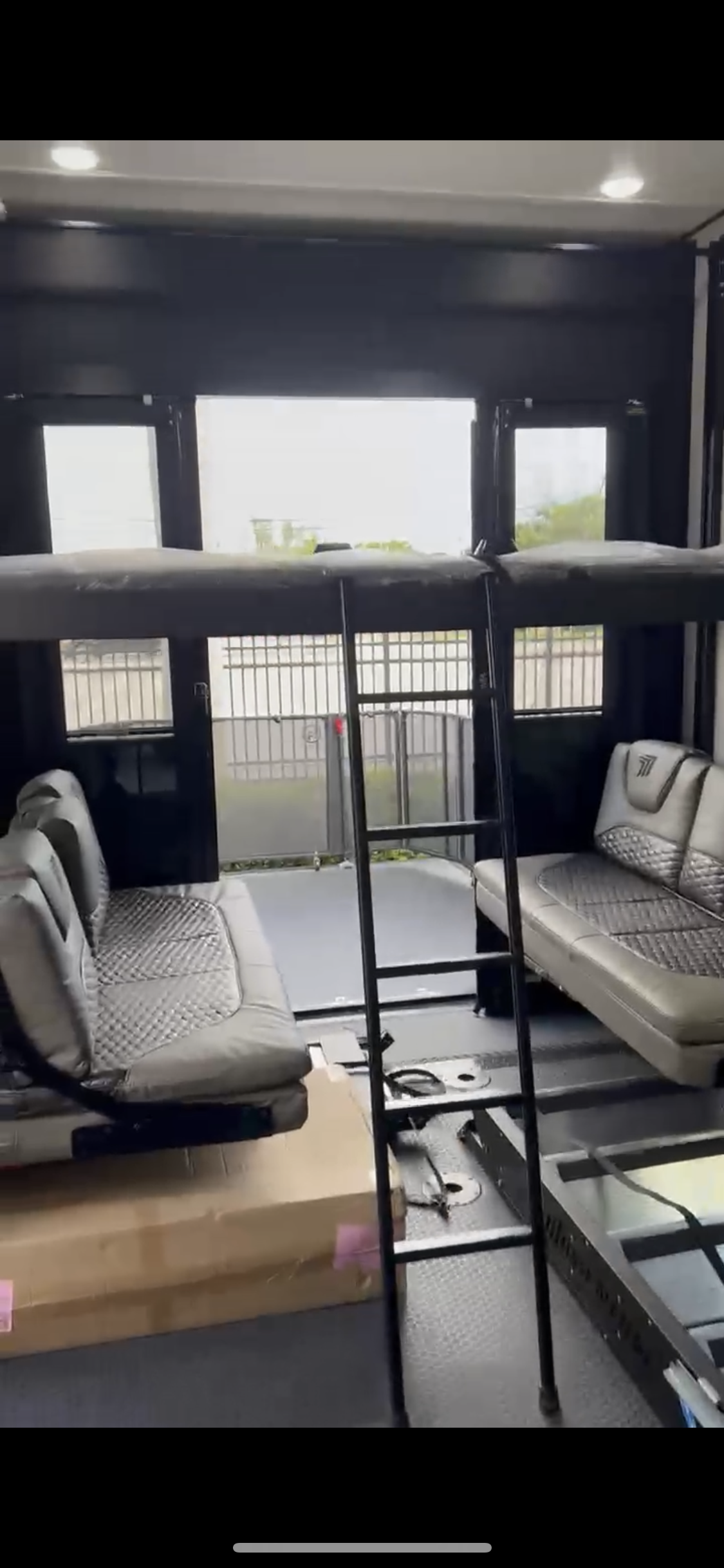 RV rental toy hauler interior with lowered bunk beds, modular seating, and a rear ramp. Great for group travel.. Grand Design Momentum Toy Hauler 2022