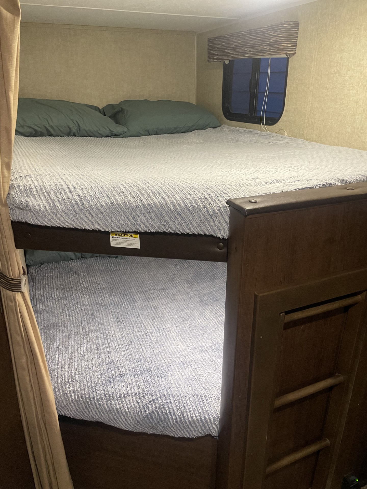 Cozy RV rental bunk beds with a ladder and window. Perfect for families or groups on an adventure.. Keystone Hideout 2017