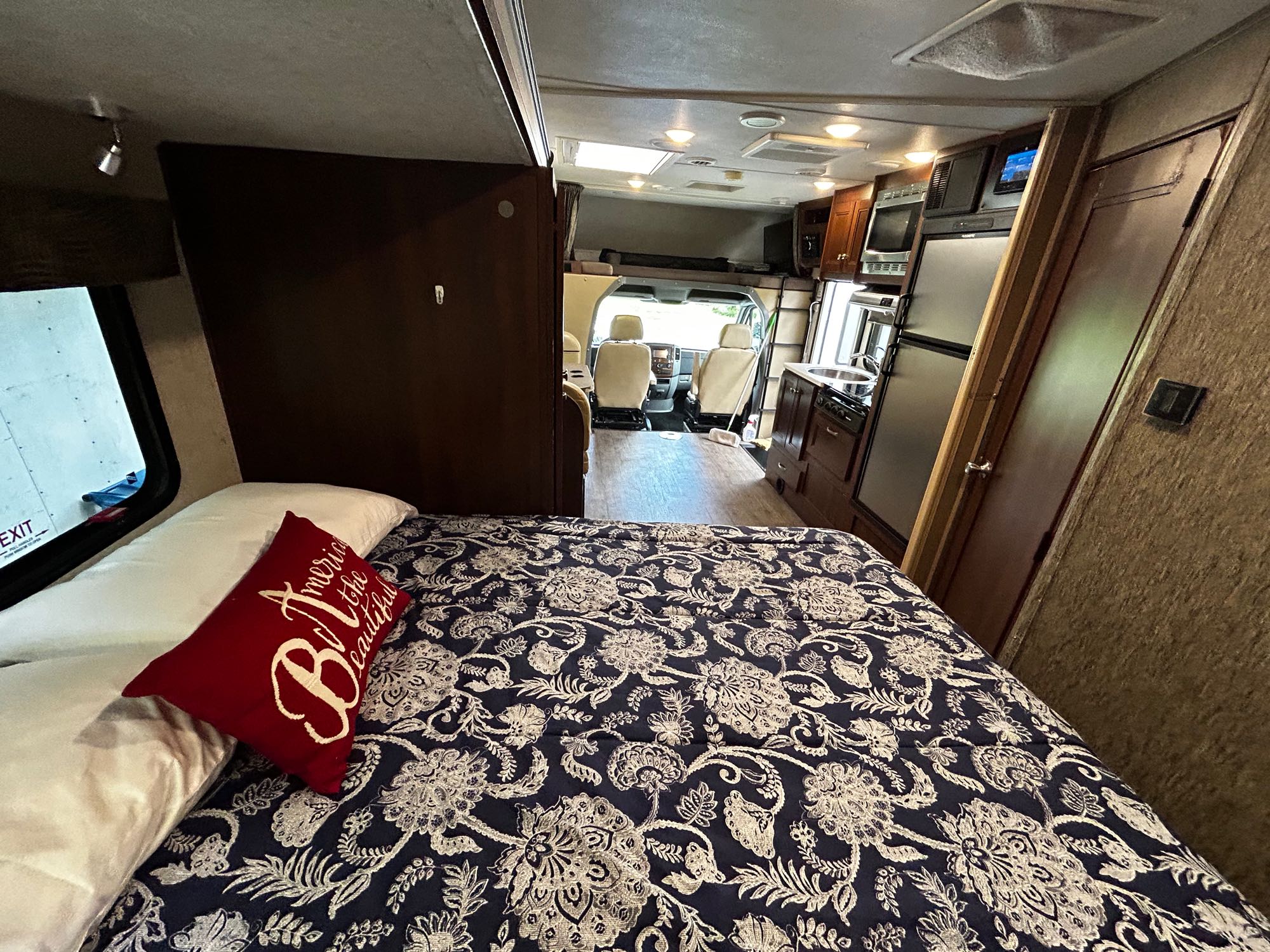 This RV rental's inviting interior features a cozy bed, full kitchen, and spacious front cabin.. Forest River Forester 2018