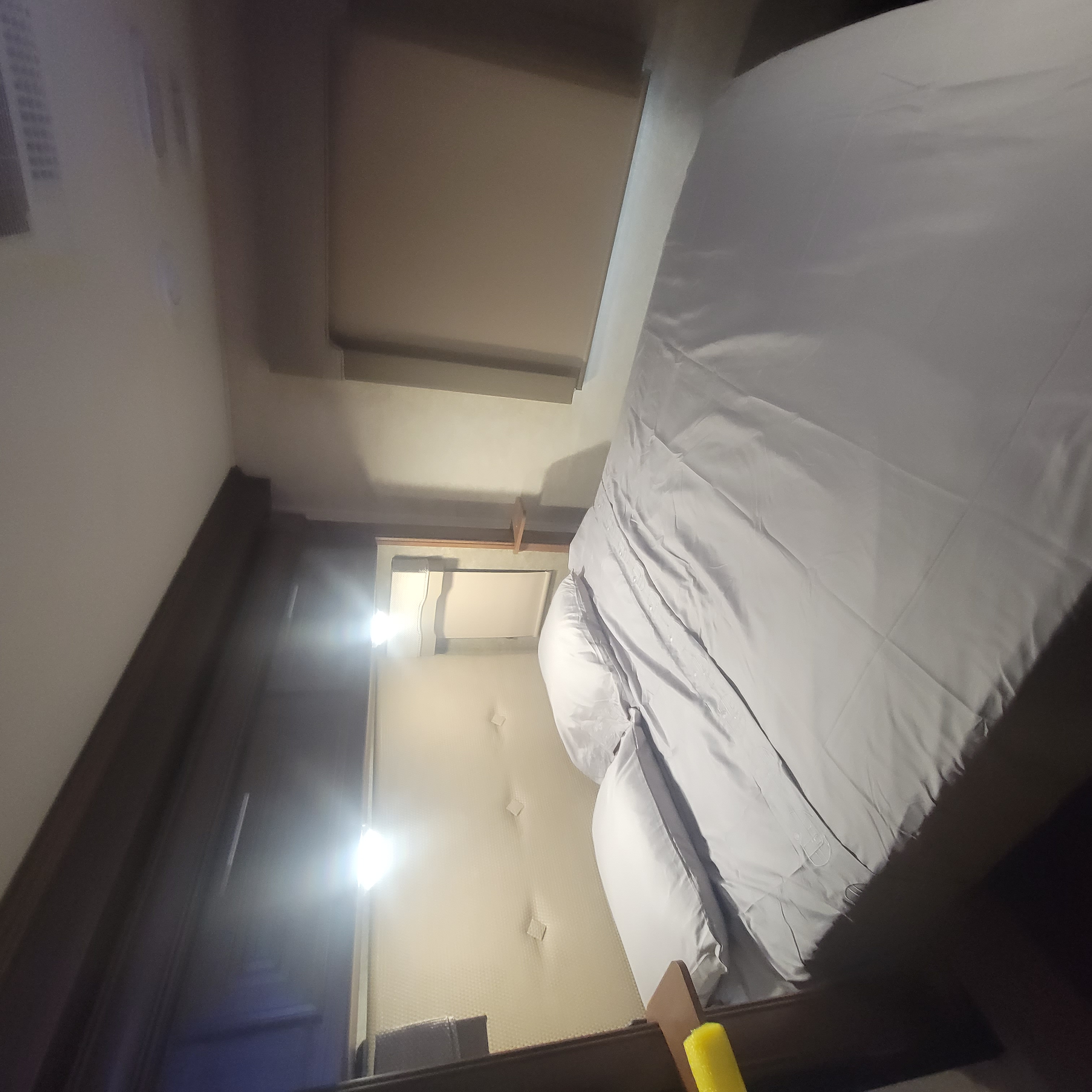 Comfortable RV rental bedroom with made bed, grey bedding, and warm lighting, perfect for travel.. Georgetown GT5 2017