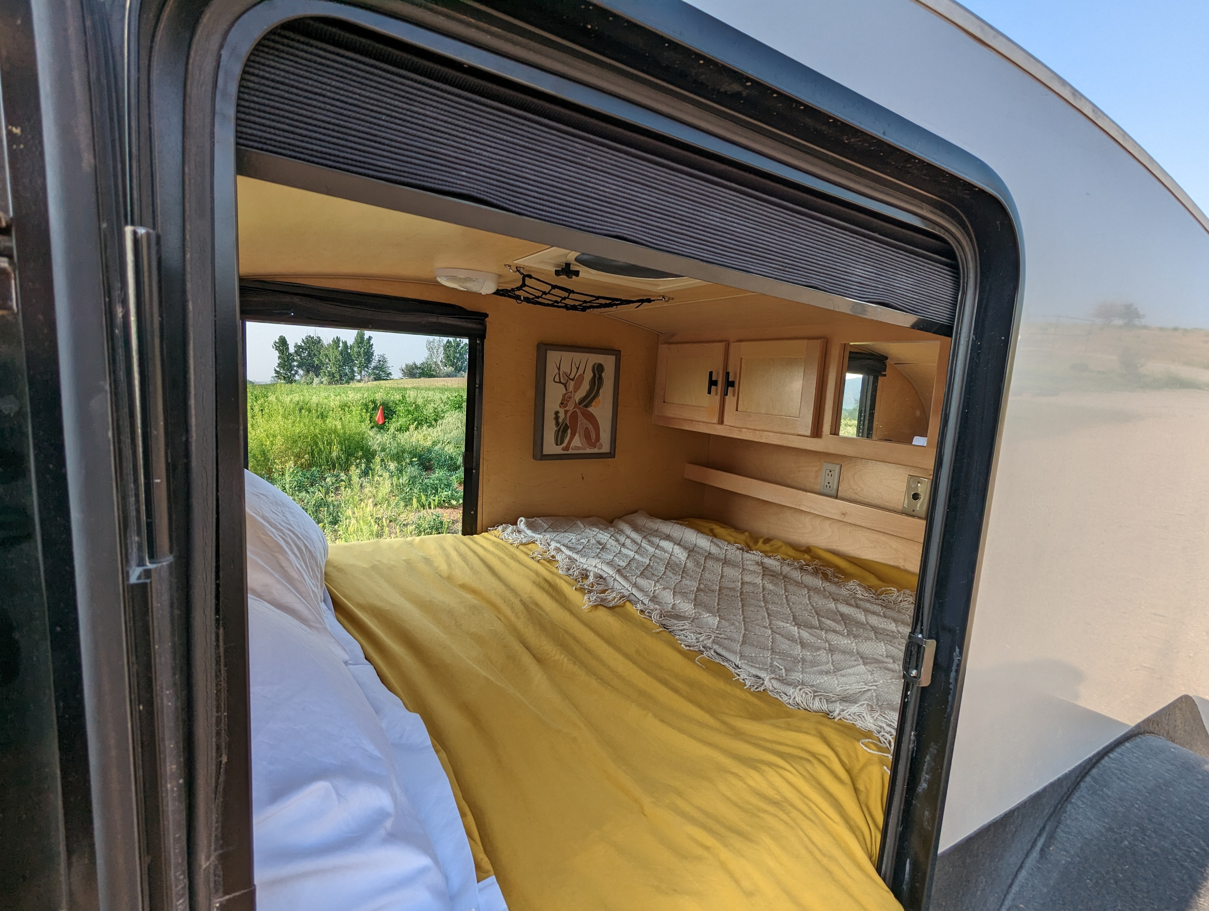 Relax in this inviting RV rental with a comfy bed, warm wood accents, and a picturesque field view.. Little Guy Silver Shadow 2011