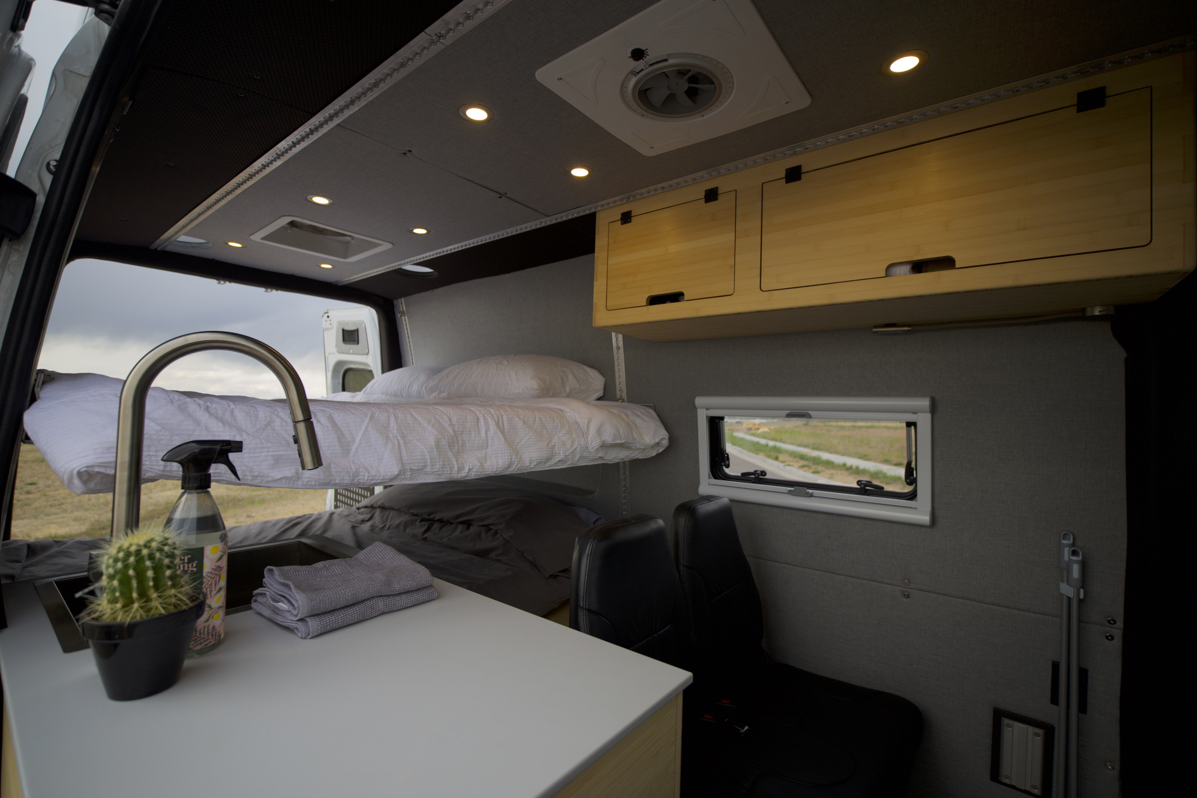 Comfortable RV rental interior: bunk beds, kitchen, and overhead storage for your next adventure.. Mercedes-Benz Sprinter 2019