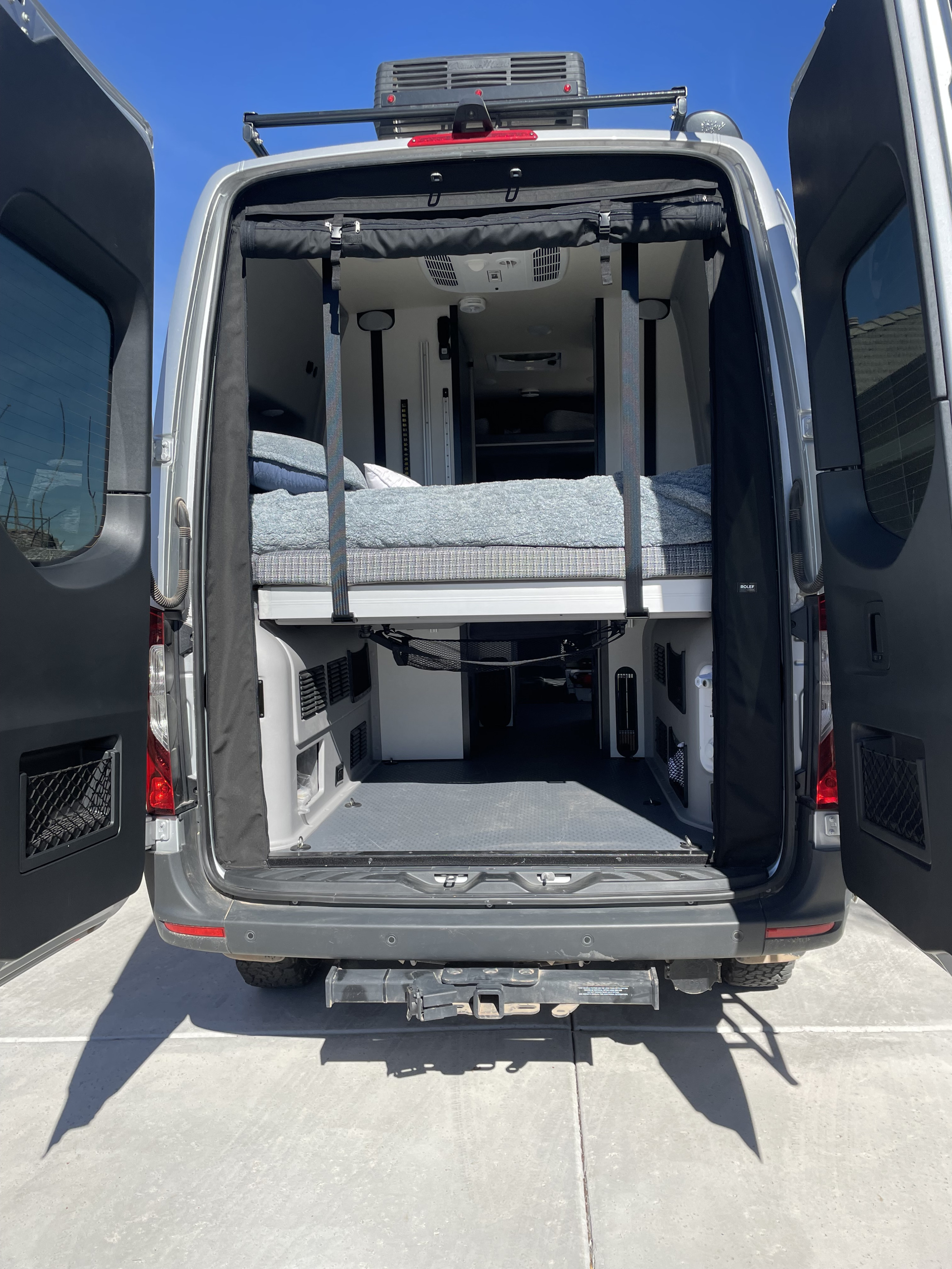 Bed can sleep two adults comfortably and the van has engineered pop outs to allow for longer length guests. AC right above to keep you cool at night!. Winnebago Revel 2022
