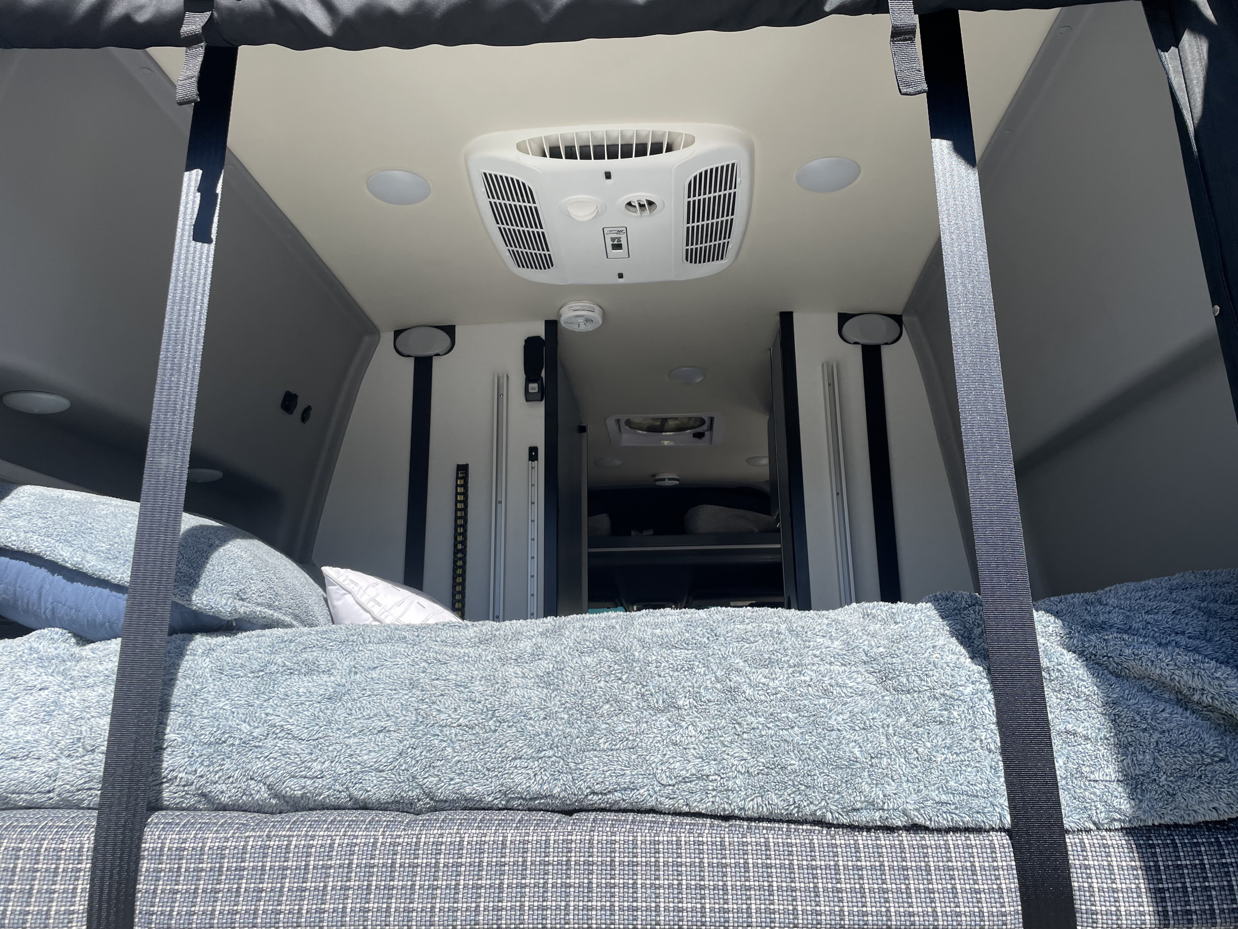 Bed can lift up during the day and be stored to the ceiling if needed. Air Conditioner can keep your rig cool on the hot days.. Winnebago Revel 2022