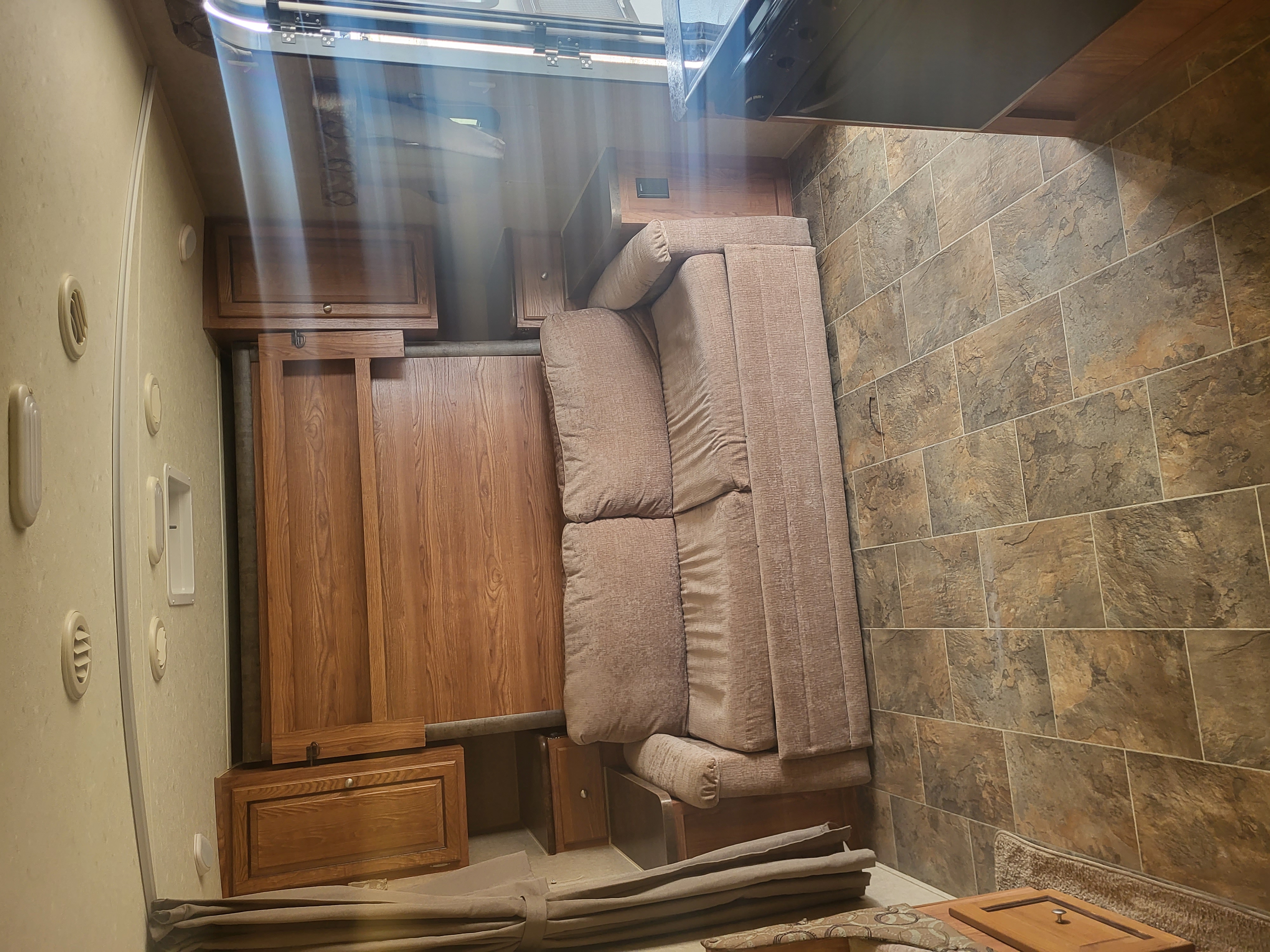 Couch with the murphy bed behind. Forest River Rockwood Mini Lite 2015