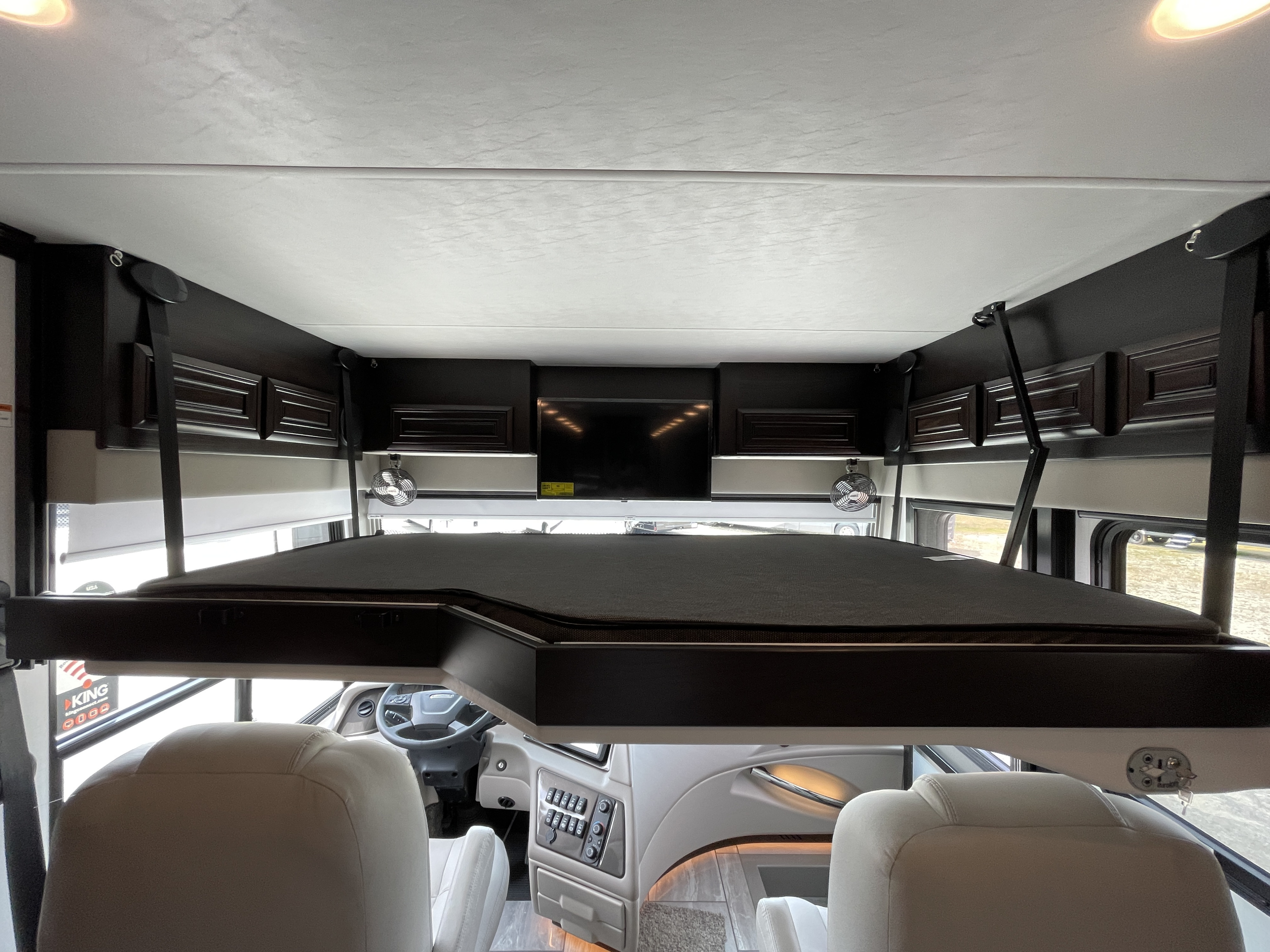 Spacious RV rental interior with retractable bunk over driver's cabin, perfect for extra sleeping space.. Berkshire XLT 2023