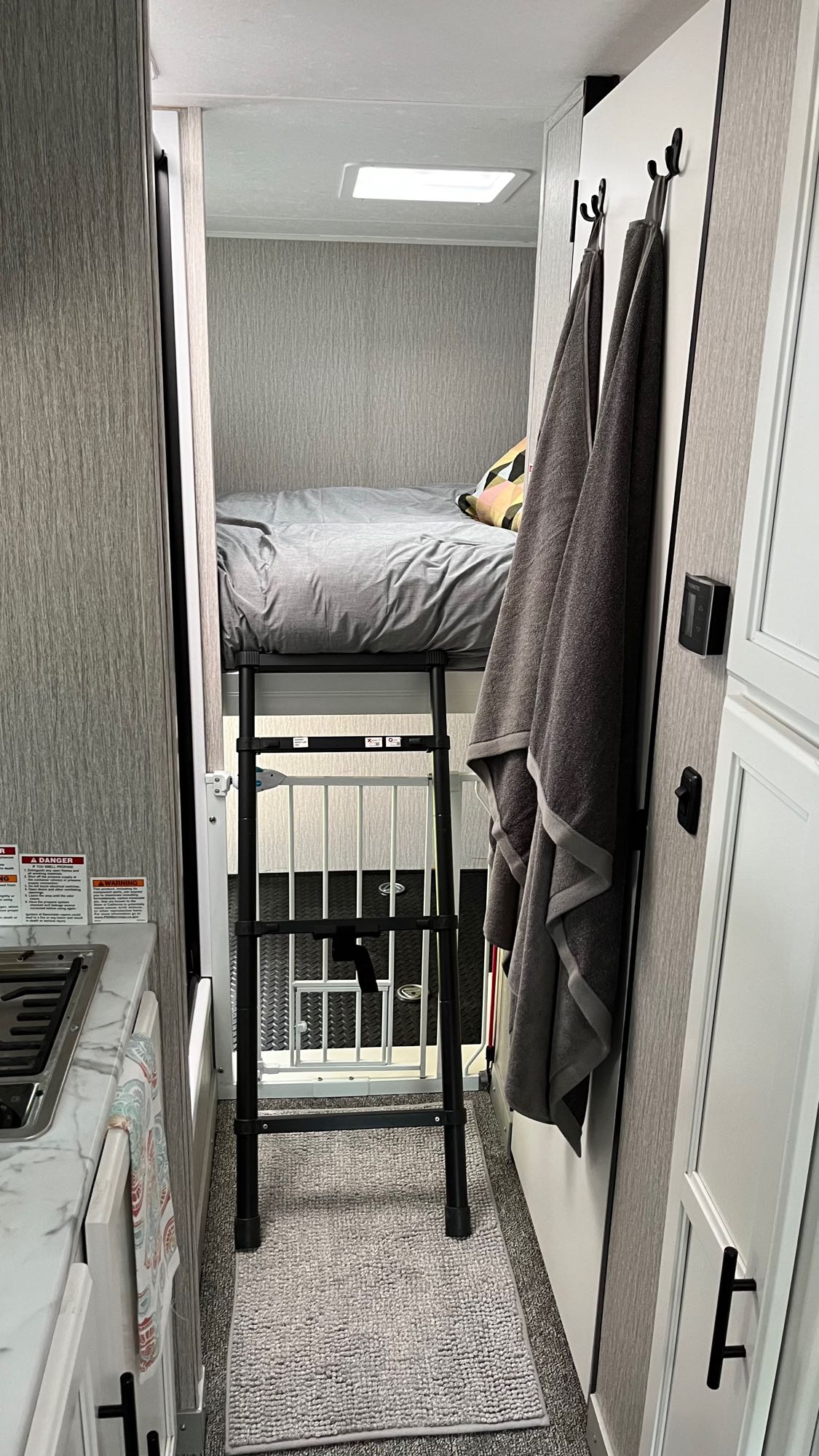Explore this RV rental's clever use of space: bunk bed with ladder, kitchen, and pet-friendly area visible.. Forest River Coachmen Cross Trail XL 2023