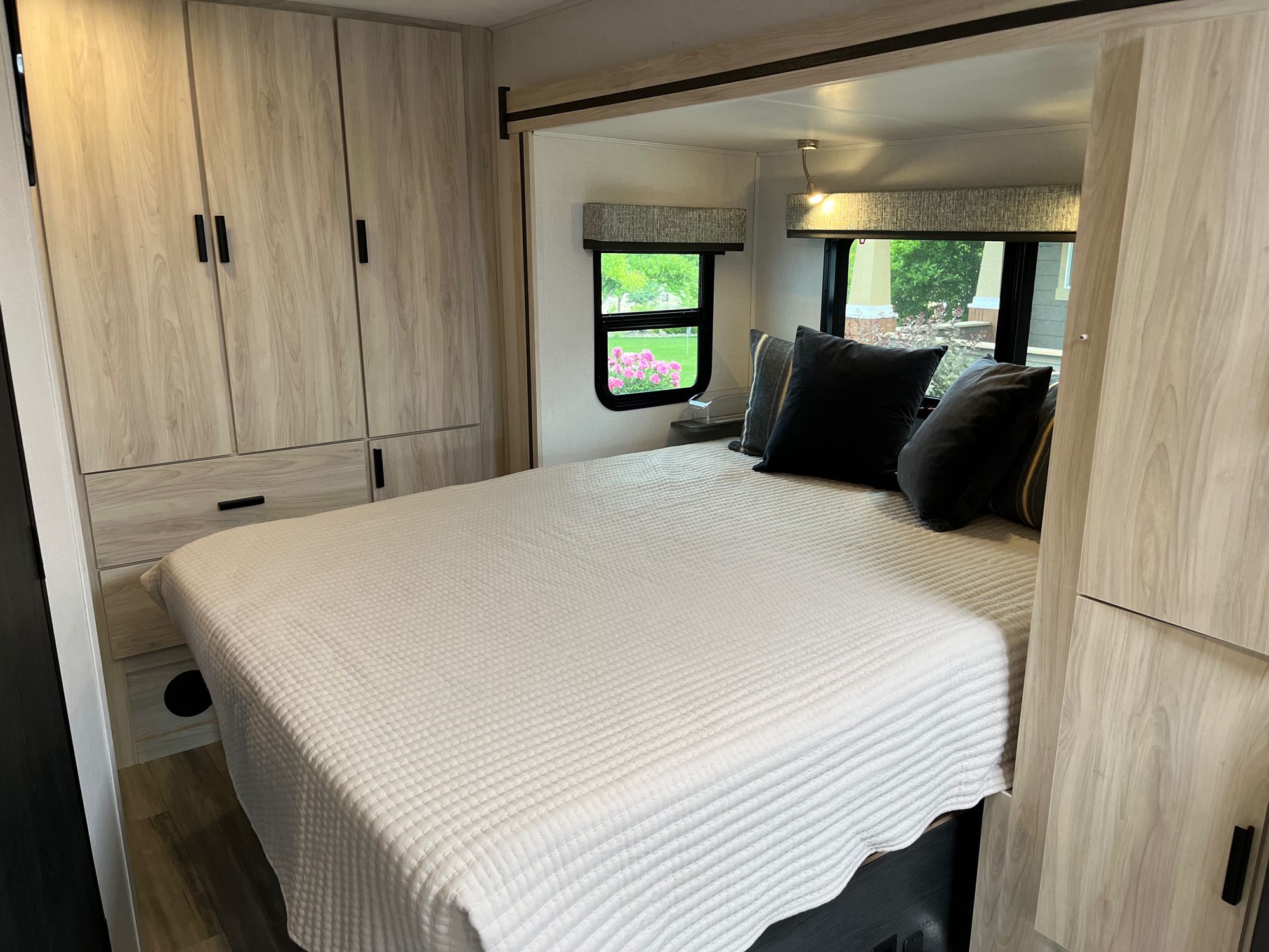 Comfortable RV rental bedroom featuring a large bed, ample storage, and scenic window views for a relaxing stay.. Forest River Forester 2401B 2023