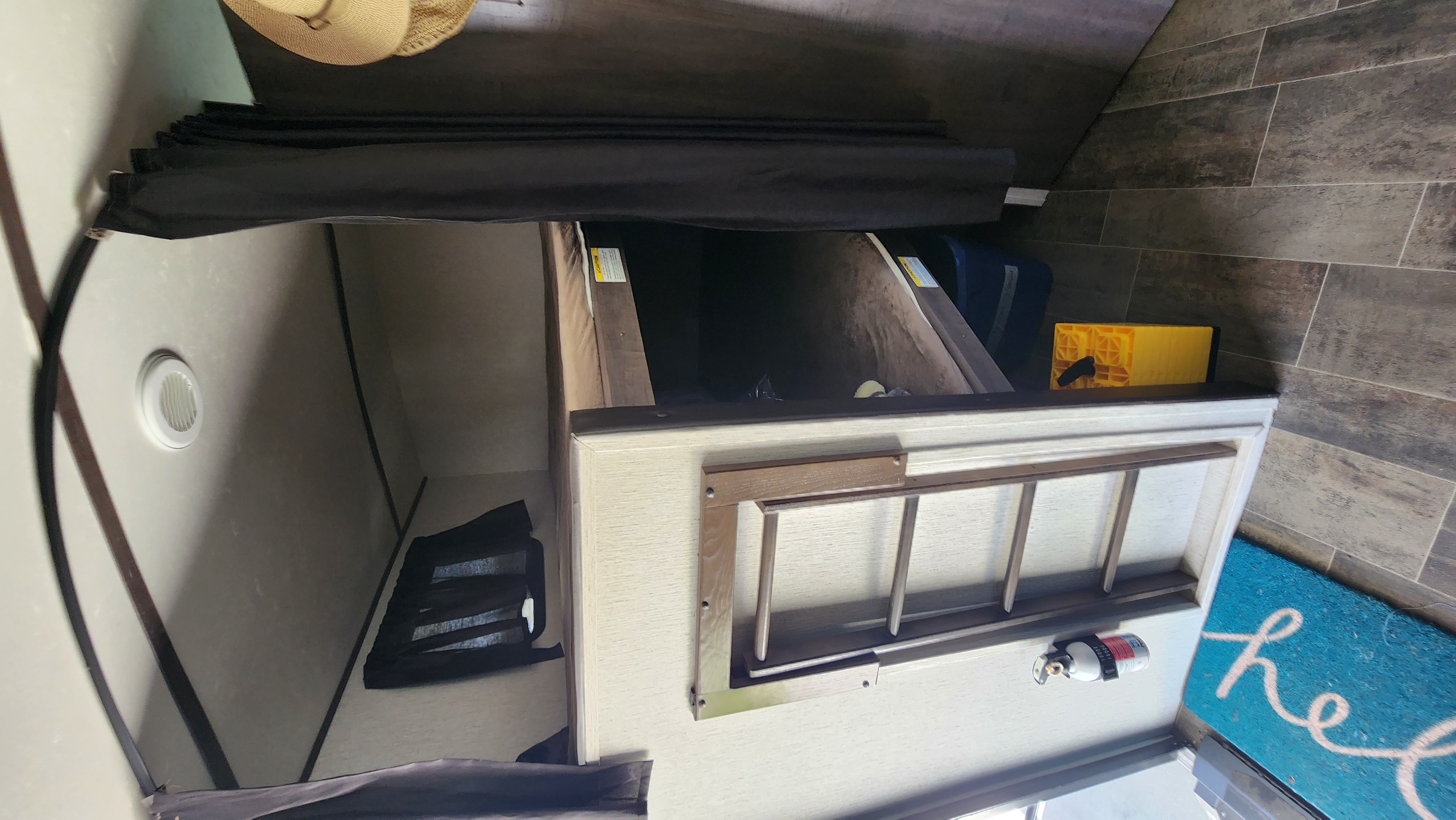 RV rental interior shows bunk beds with a wooden ladder, built-in storage cubbies, and a mounted fire extinguisher.. Crossroads RV Sunset Trail Super Lite 2019