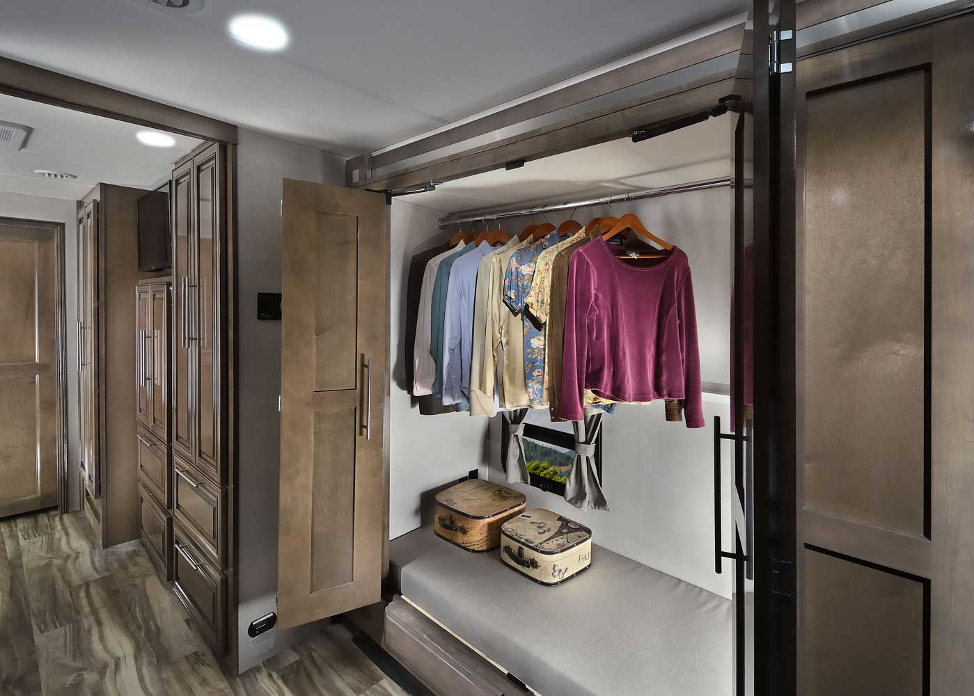 RV rental: Efficient pull-down wardrobe, bench, and storage solutions for organized compact living.. Forest River Georgetown 2022