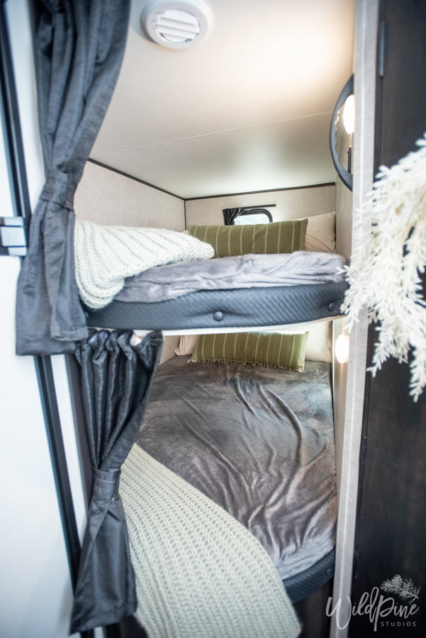 Comfortable bunk beds in an RV rental, featuring soft bedding and pillows. Ideal for family adventures & compact living.. Jayco 242BHSW 2023