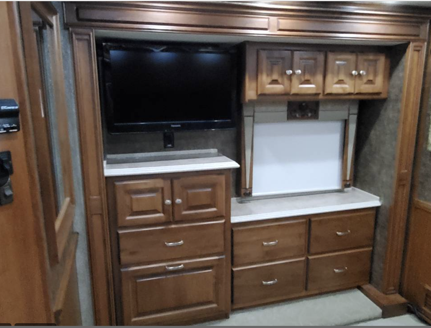 RV rental bedroom interior: TV, overhead & base cabinets, multiple storage drawers. A well-organized space for travel.. Phaeton Phaeton Motorhome 2011