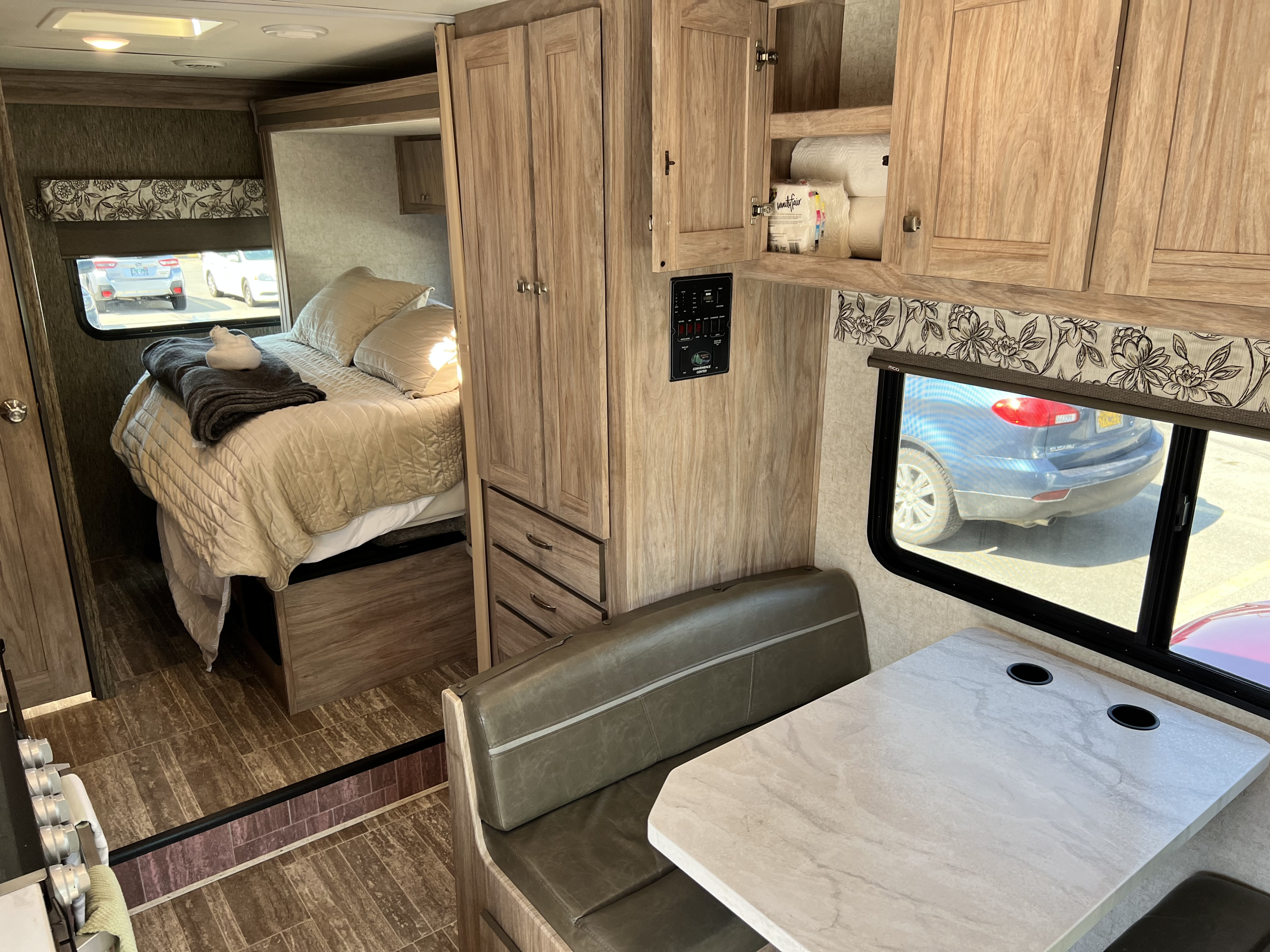 Spacious rv rental interior shows bedroom, dinette, and wood-look storage, perfect for travel.. Forest River Forester 2018