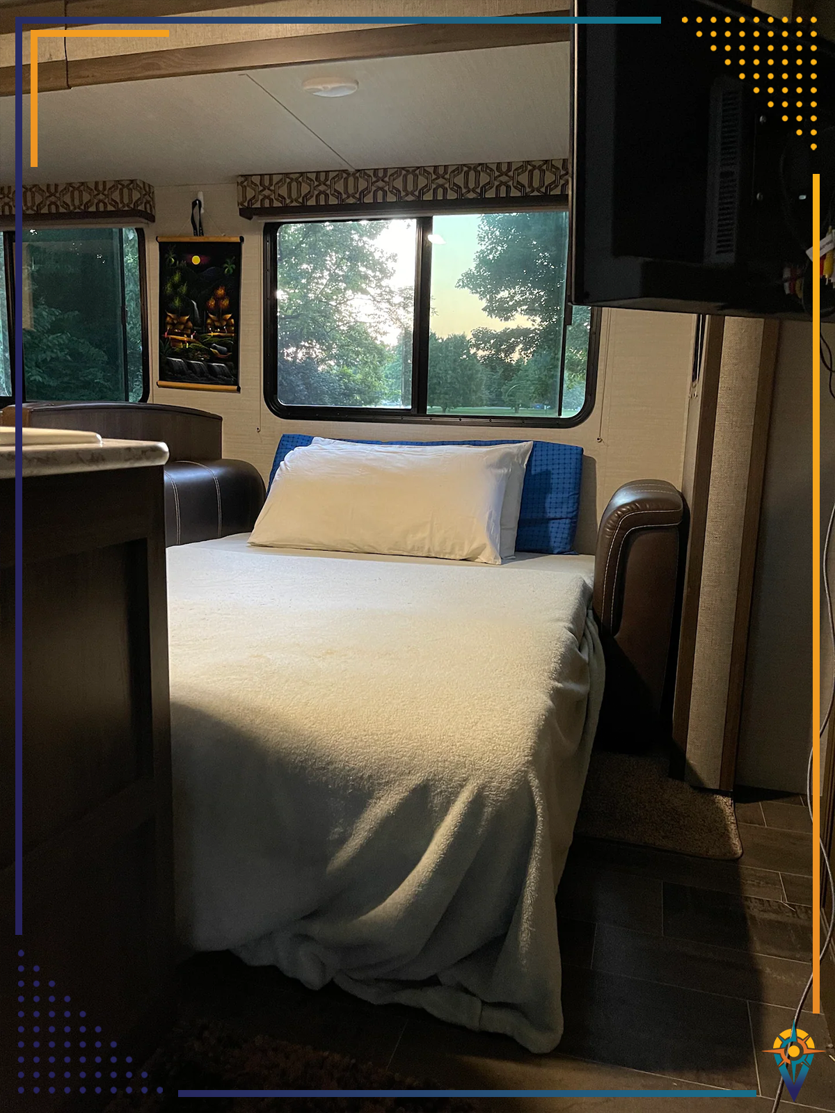 RV rental interior: A made bed with white linens and outdoor window views. Perfect for comfortable travel adventures.. Keystone Bullet 2018