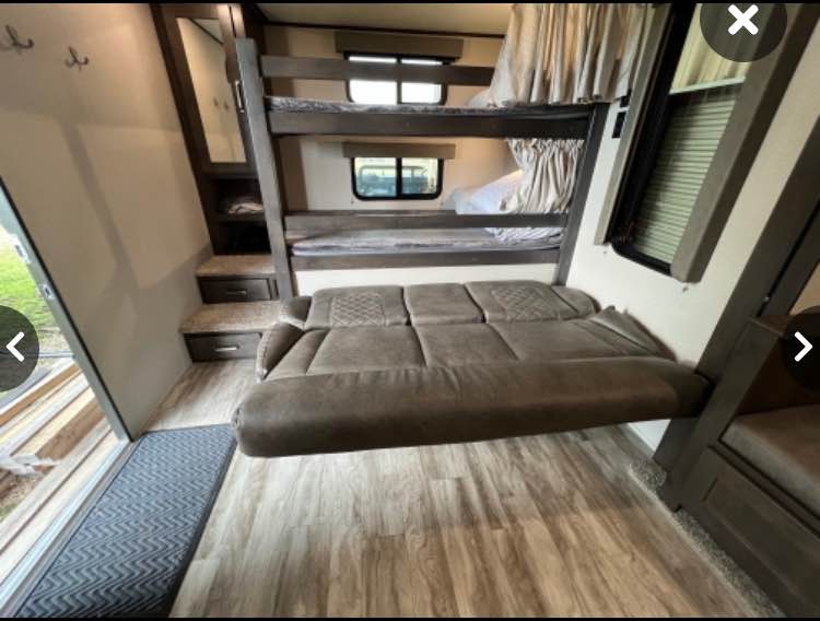 RV rental: The interior features two bunk beds, a pull-out floating sofa, and built-in storage. Ideal for travel.. Grand Design Transcend Xplor 2021