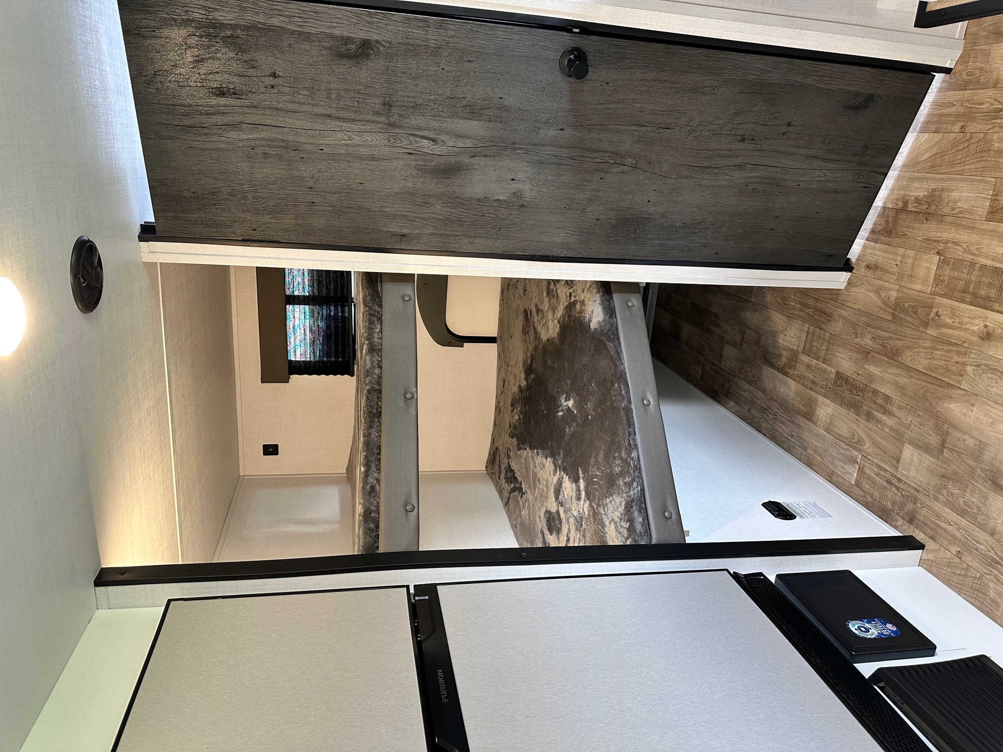 RV rental bunk beds and kitchen area reveal smart space. Furrion fridge visible. Ideal for compact living.. Hideout 181BH 2023