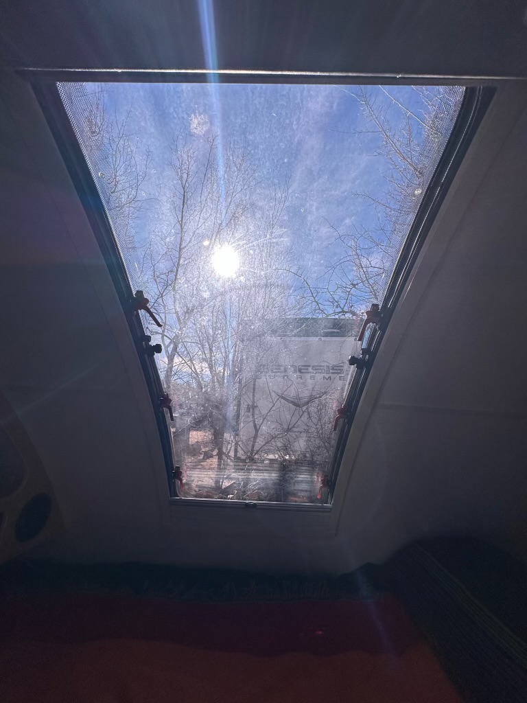 Gaze up at the bright blue sky and sun-drenched trees through this large RV rental skylight. A perfect view from your getaway.. Little Guy Little Guy Trailer 2020