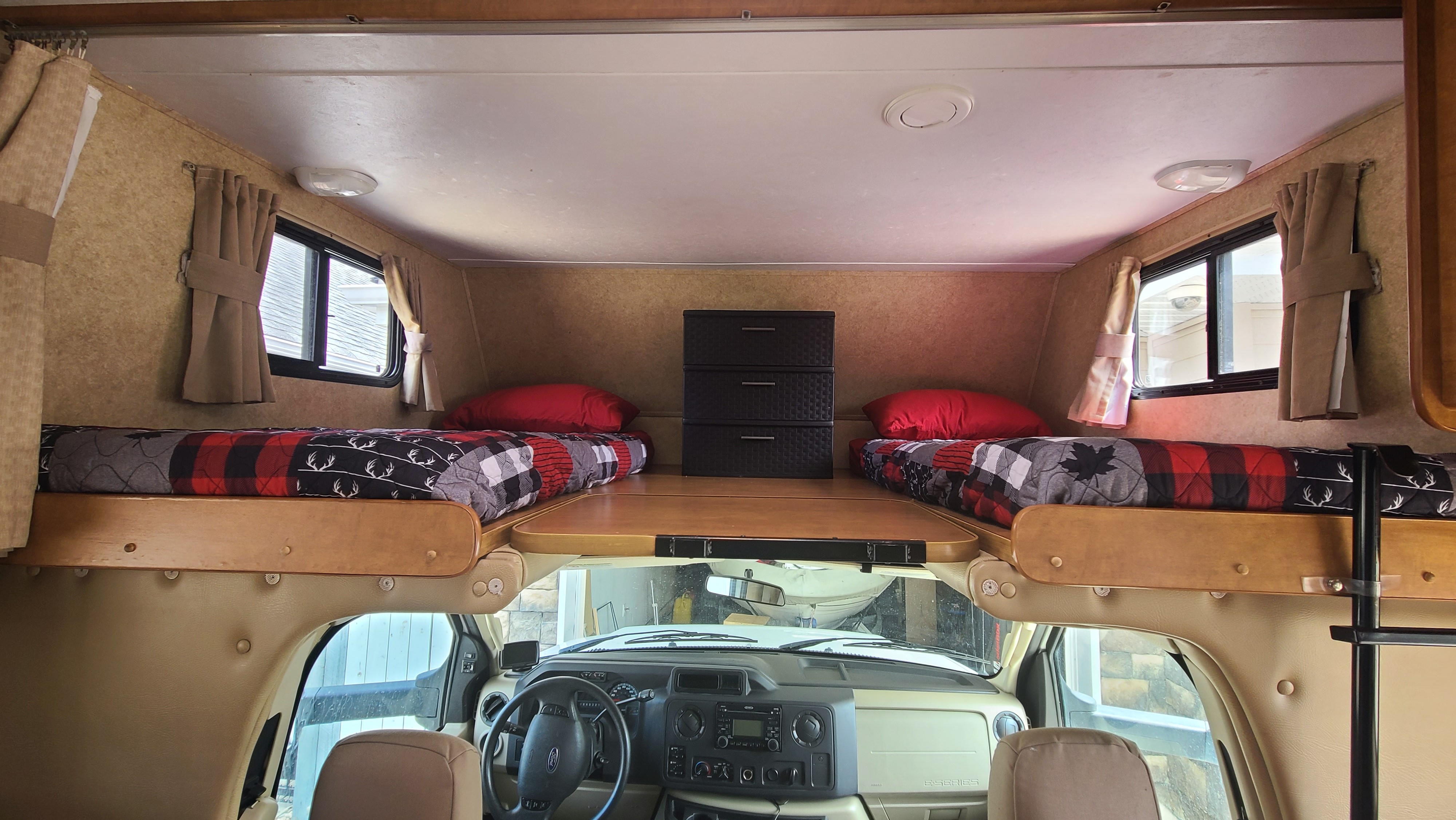 Experience comfort in this RV rental's cab-over sleeping area with twin beds & storage above the driver's seat.. Forest River Sunseeker 2011
